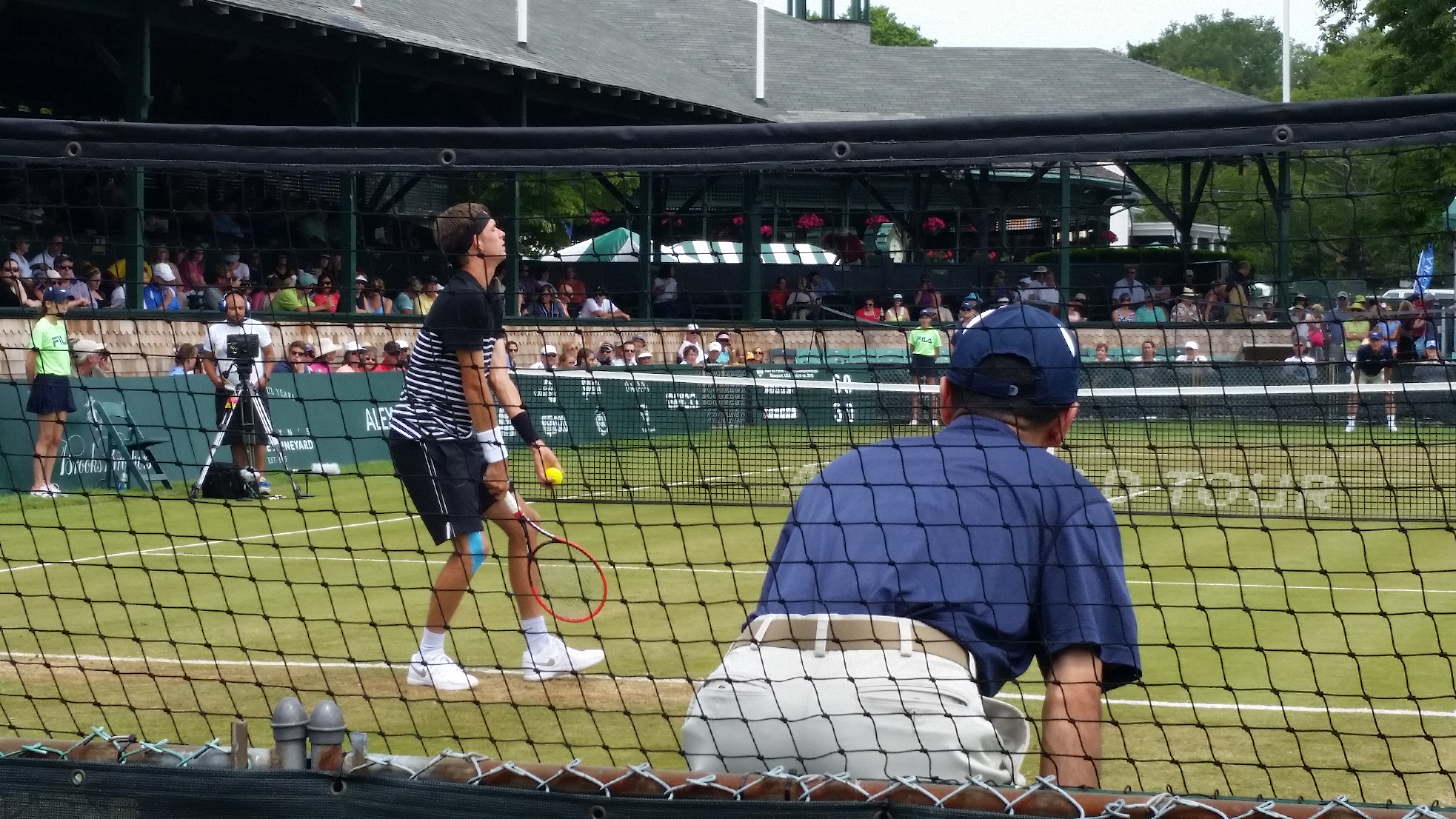 A tennis player serving on a hard court