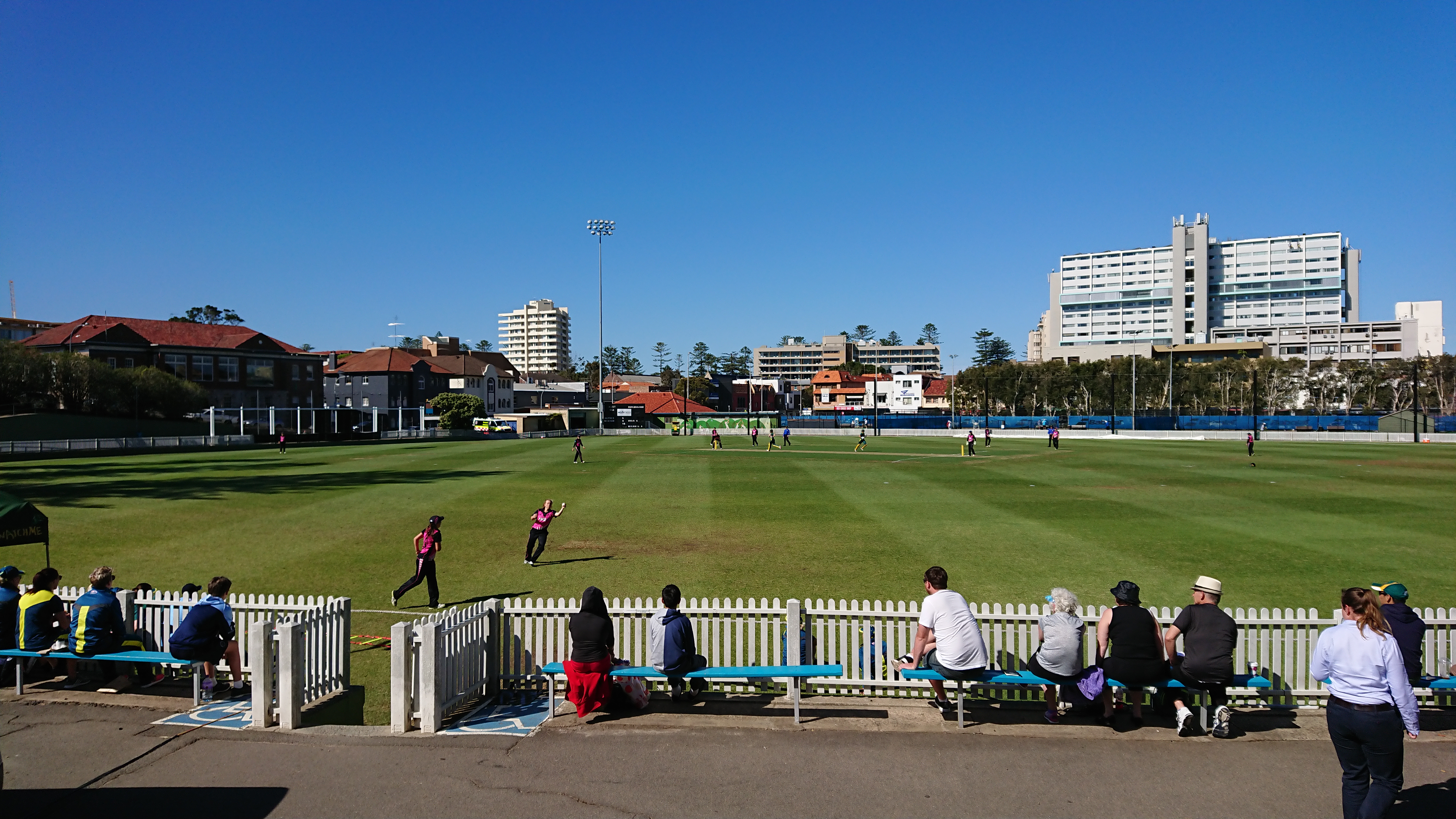 Cricket match in progress at a stadium