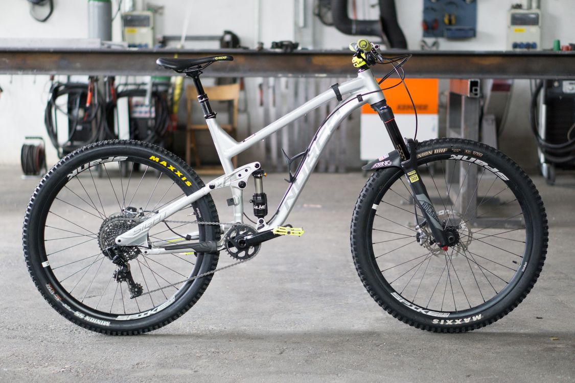 A mountain bike in a workshop, highlighting design and components