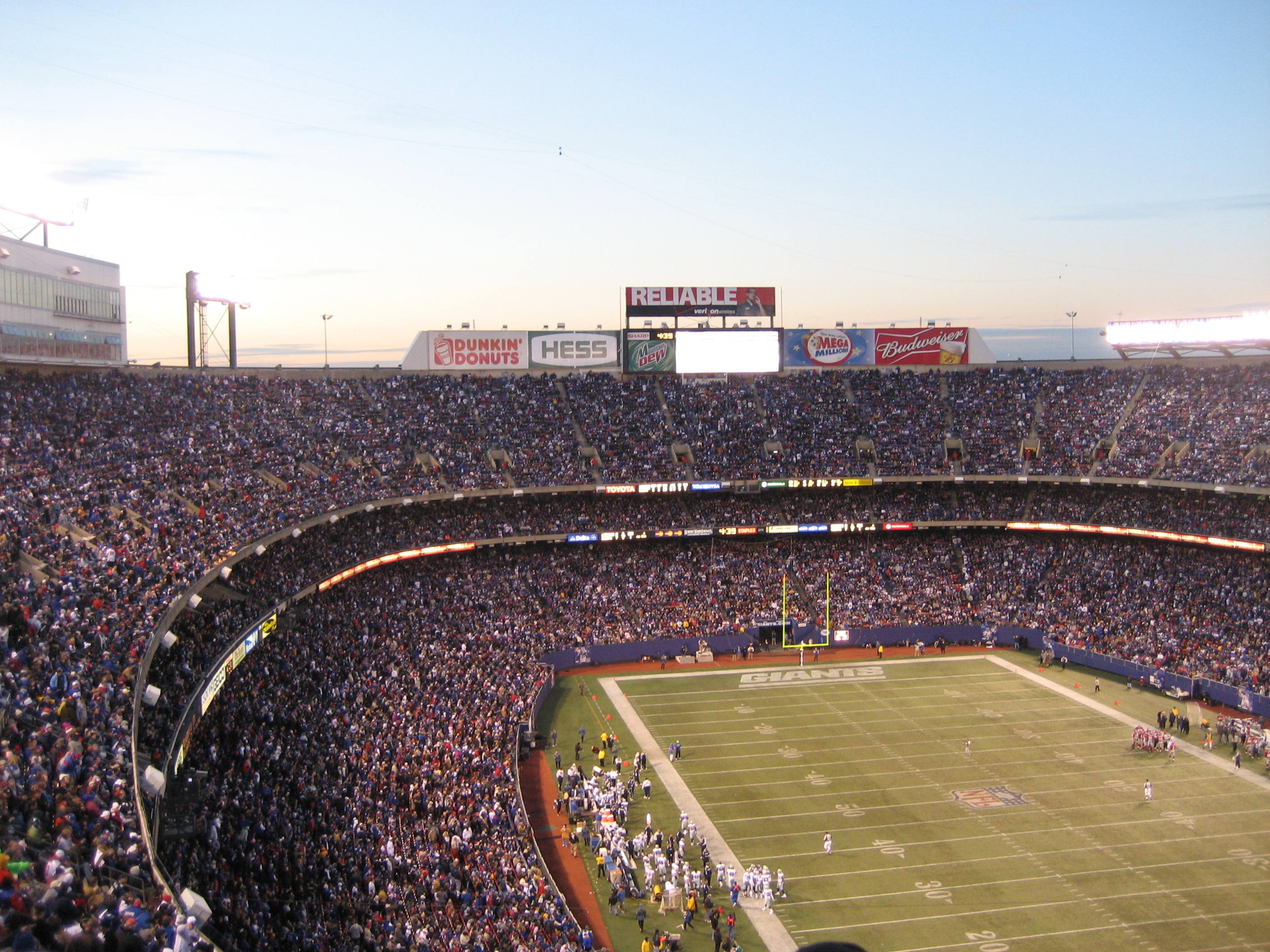 A wide view of an American football stadium during a game