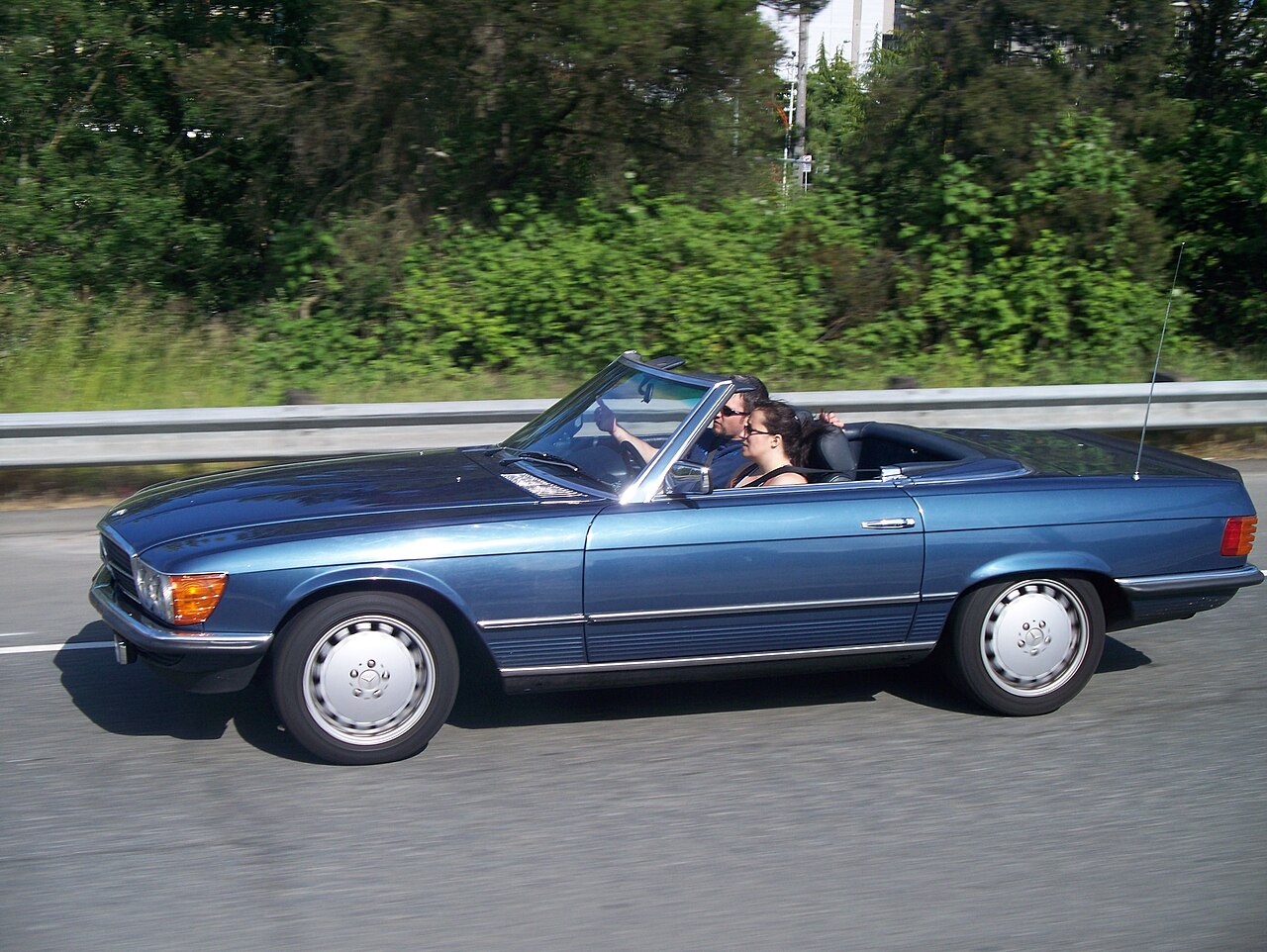 A convertible car driving on a highway