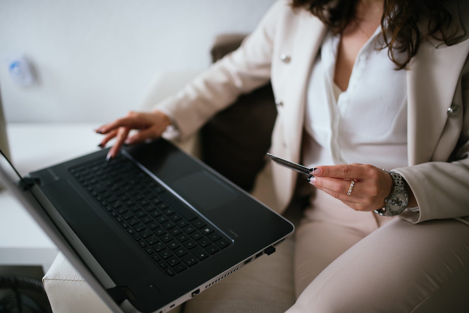A shopper using a laptop and a credit card to buy online