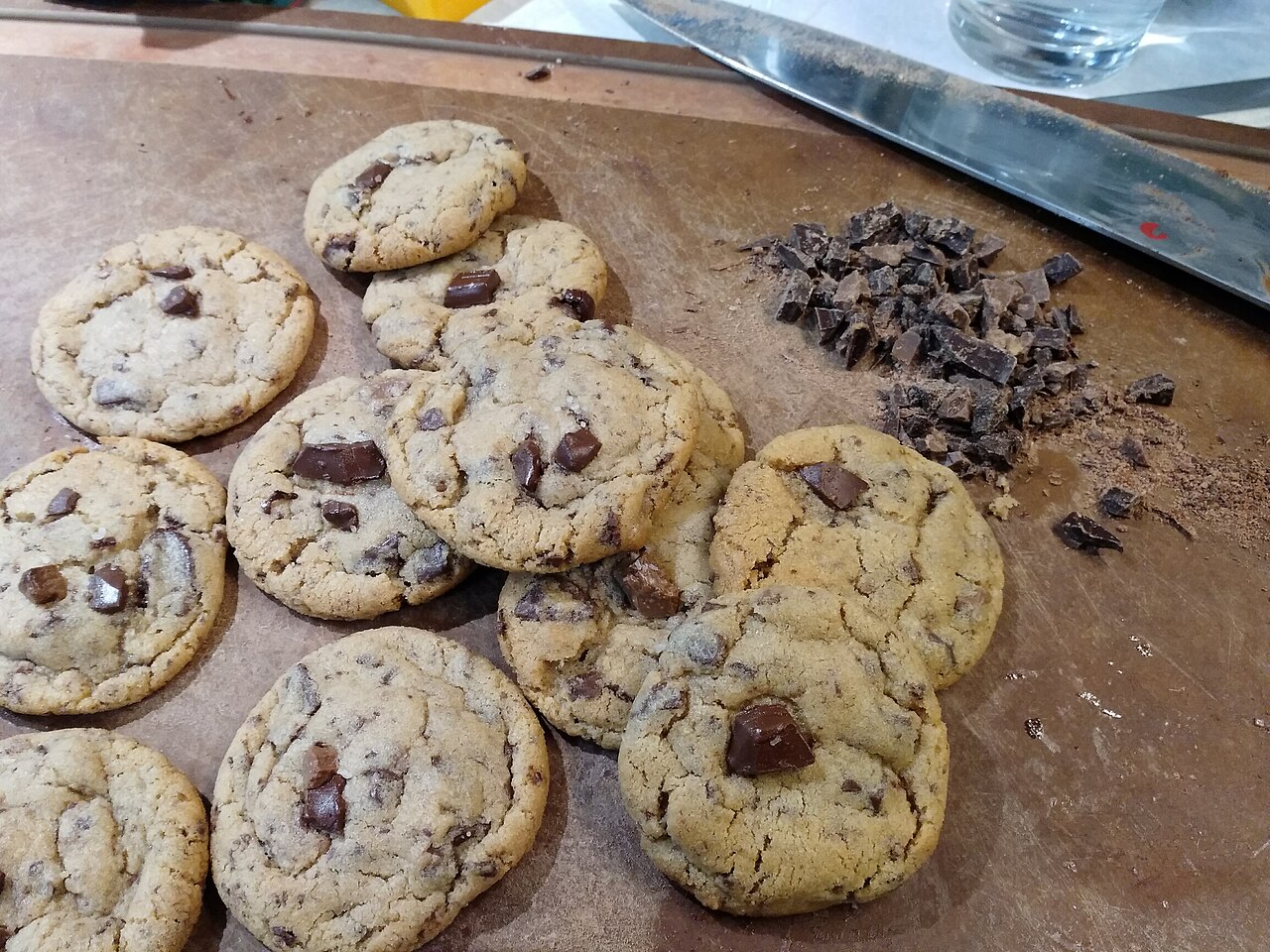 Chocolate chip cookies cooling on a cutting board