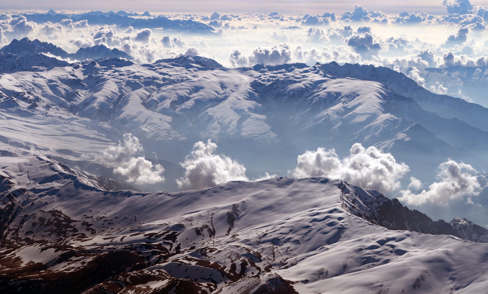 Bright snow-covered mountains under a clear sky