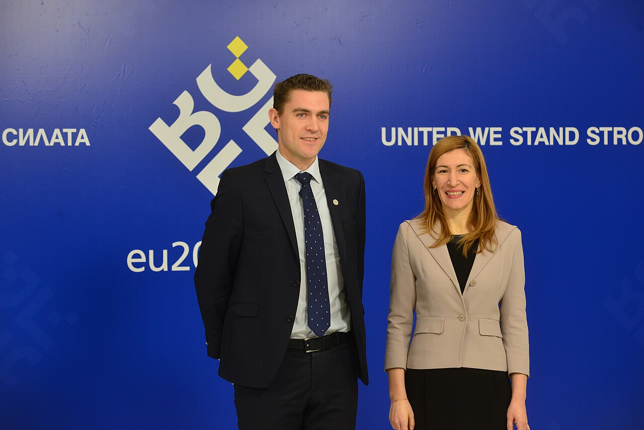 Two people shaking hands at a formal meeting