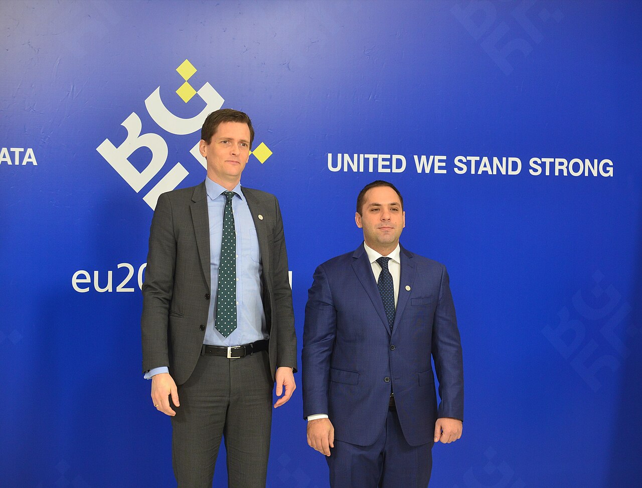 Two people shaking hands at a meeting