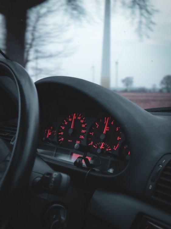 A close-up of a car speedometer showing the speed the driver wants to hold