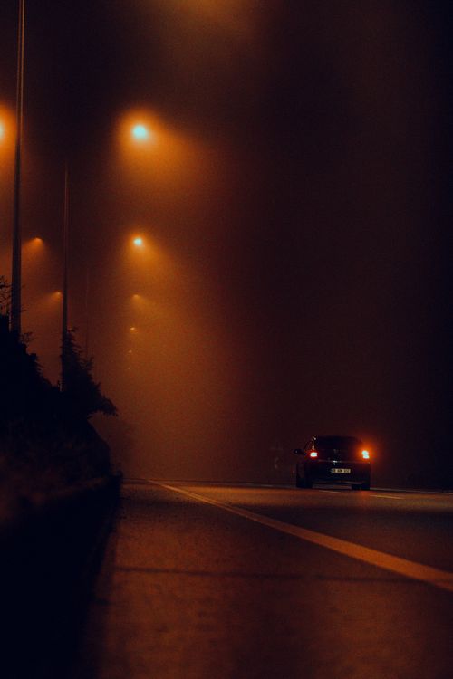A car driving on a highway at night, where steady speed matters most