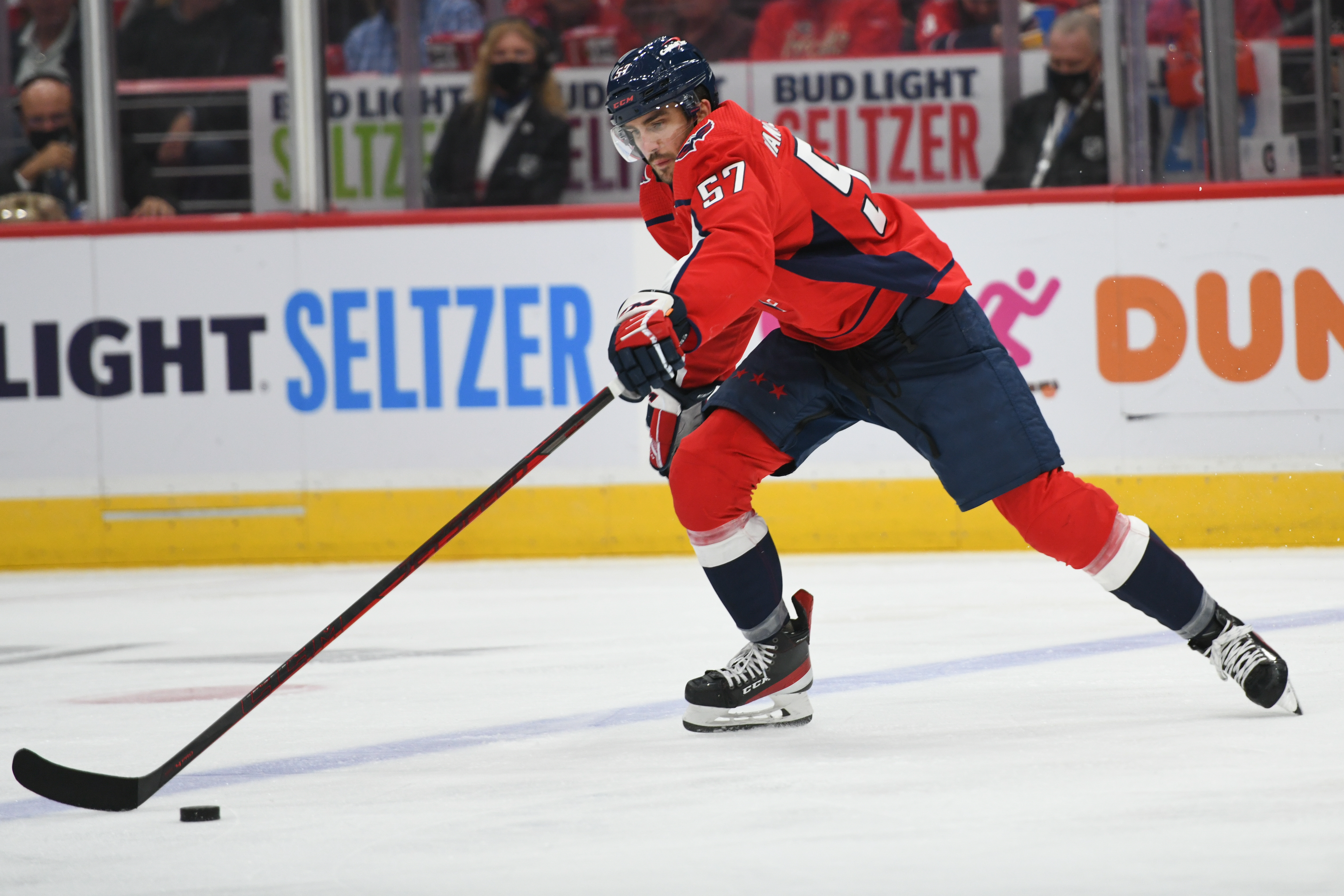 A defenceman skates with the puck during an ice hockey game