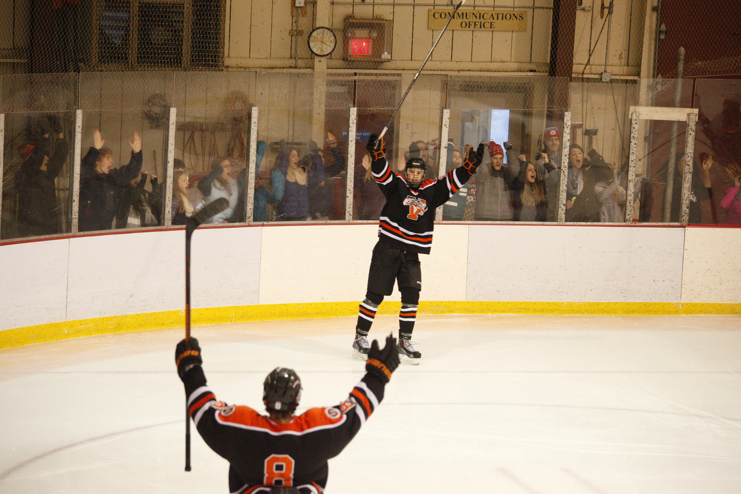 Players celebrate a goal during an ice hockey game