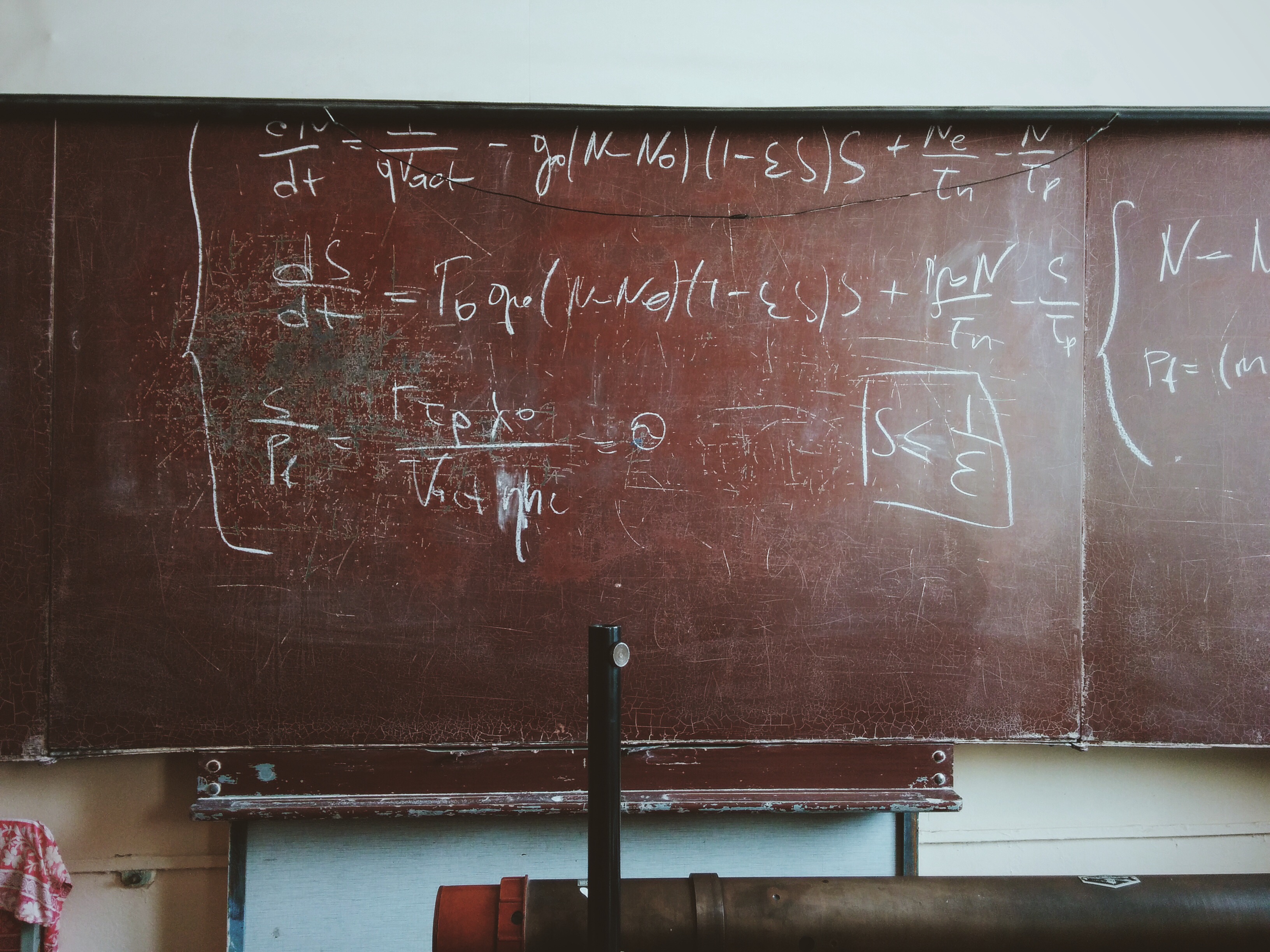 Formulas and diagrams written in chalk on an old blackboard