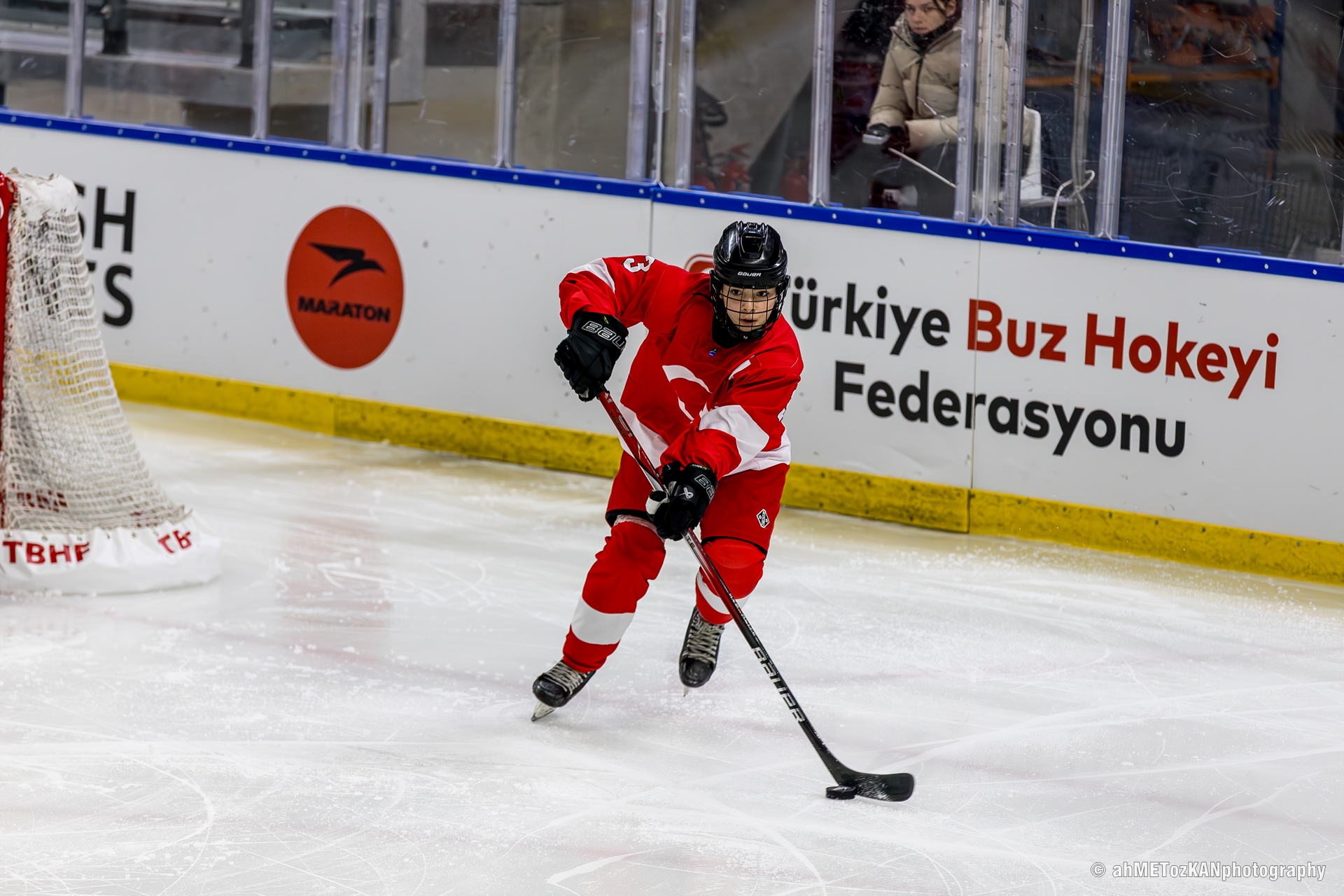 A hockey player carries the puck during a game