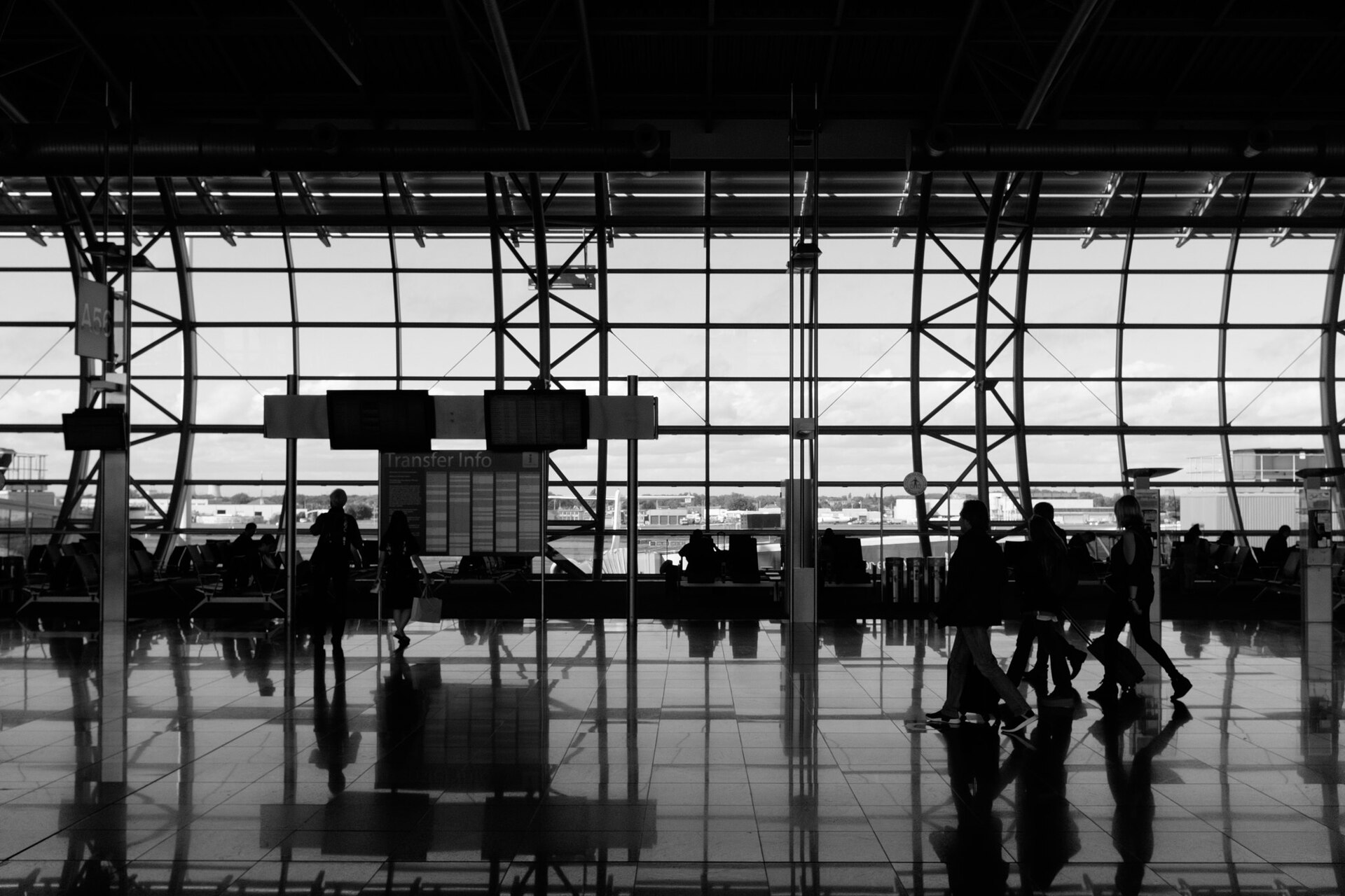 Passengers walking through a large airport terminal
