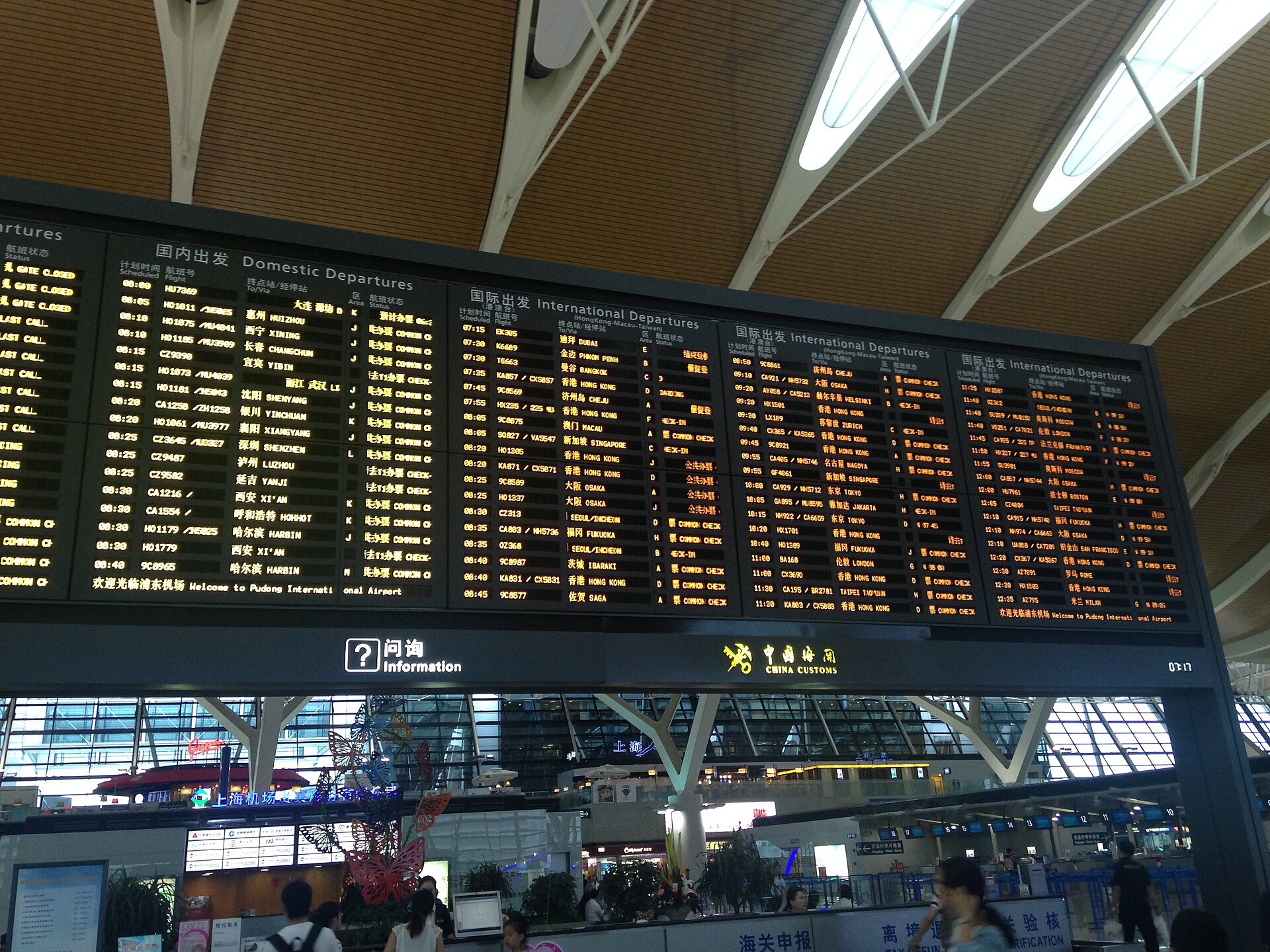 A departure board at a large international terminal