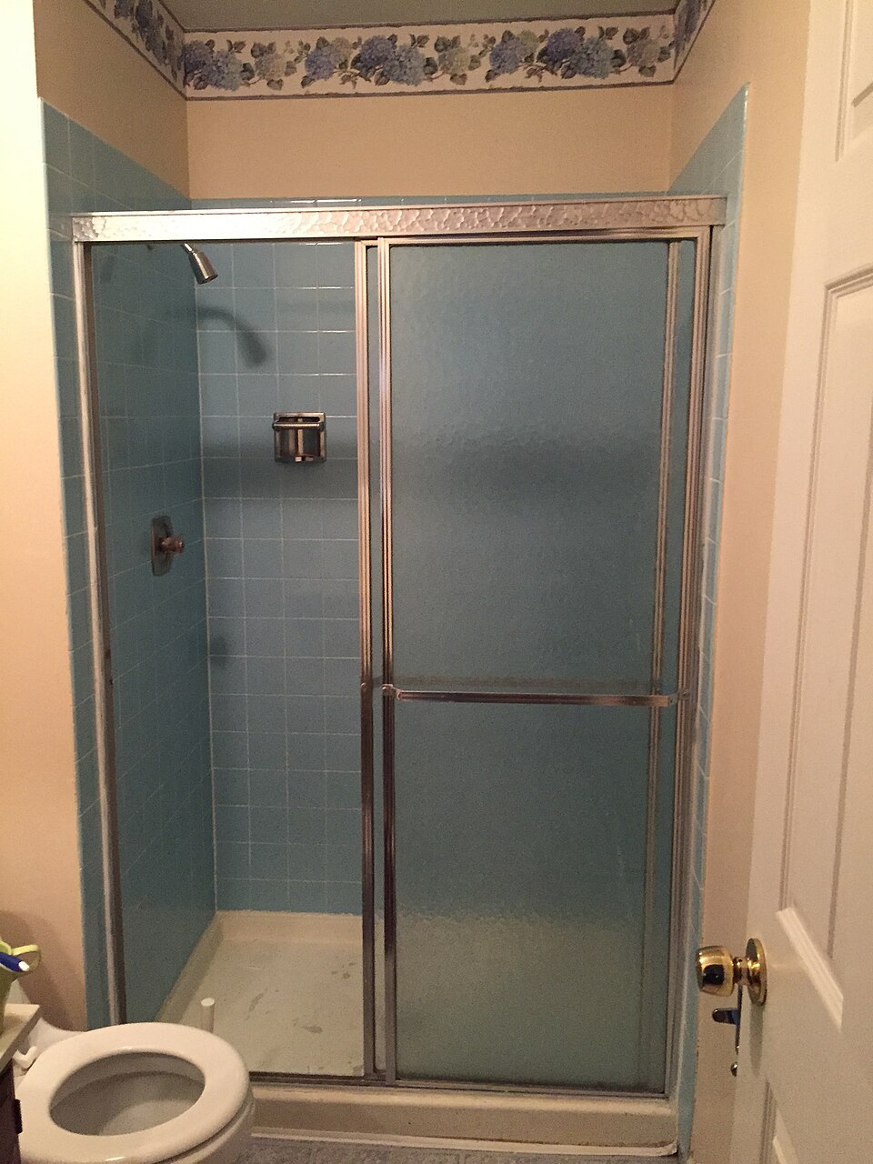 A tiled walk-in shower with grout joints