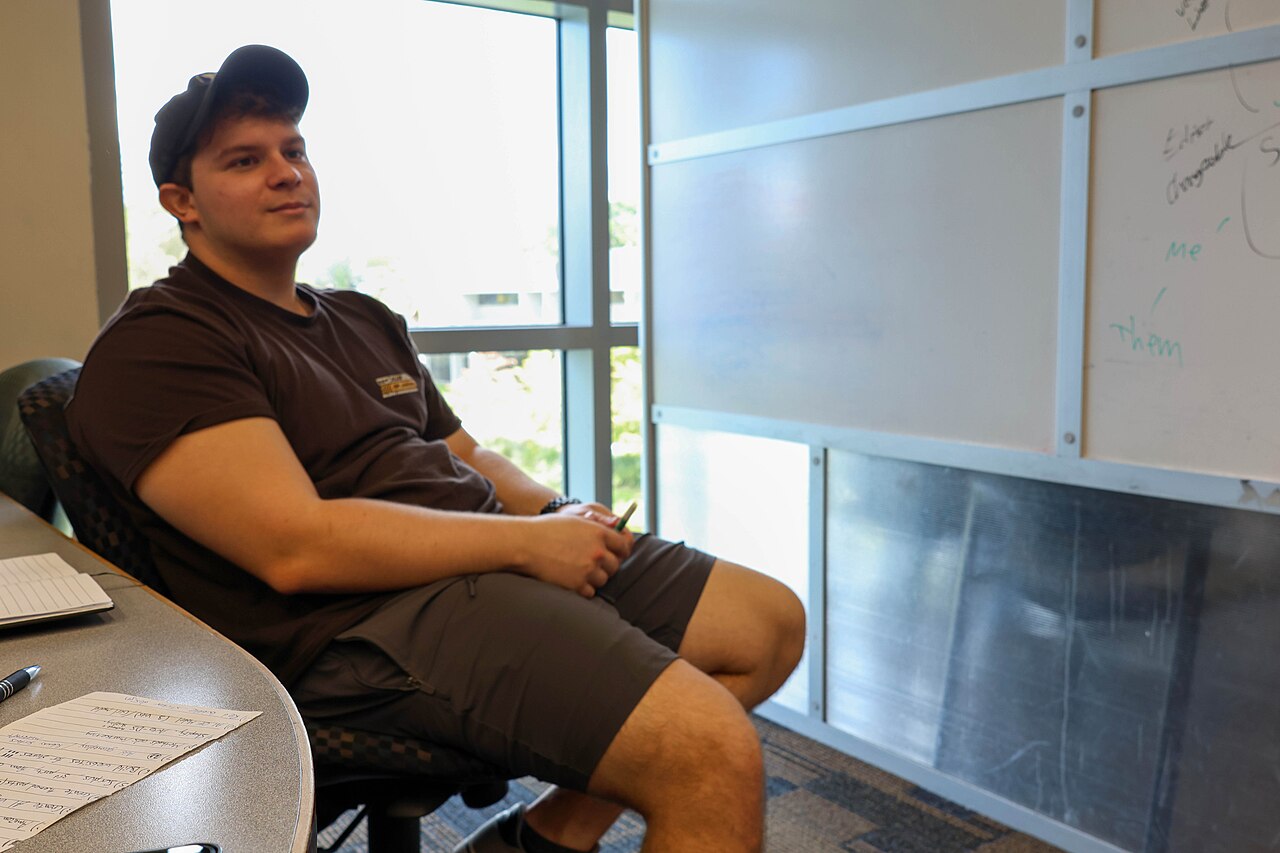 A student listening during a study session in a classroom
