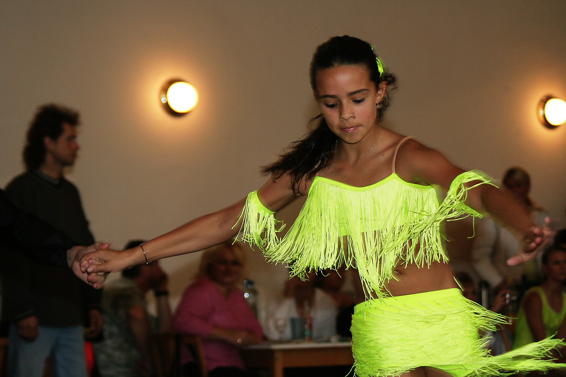 A couple dances in a ballroom competition