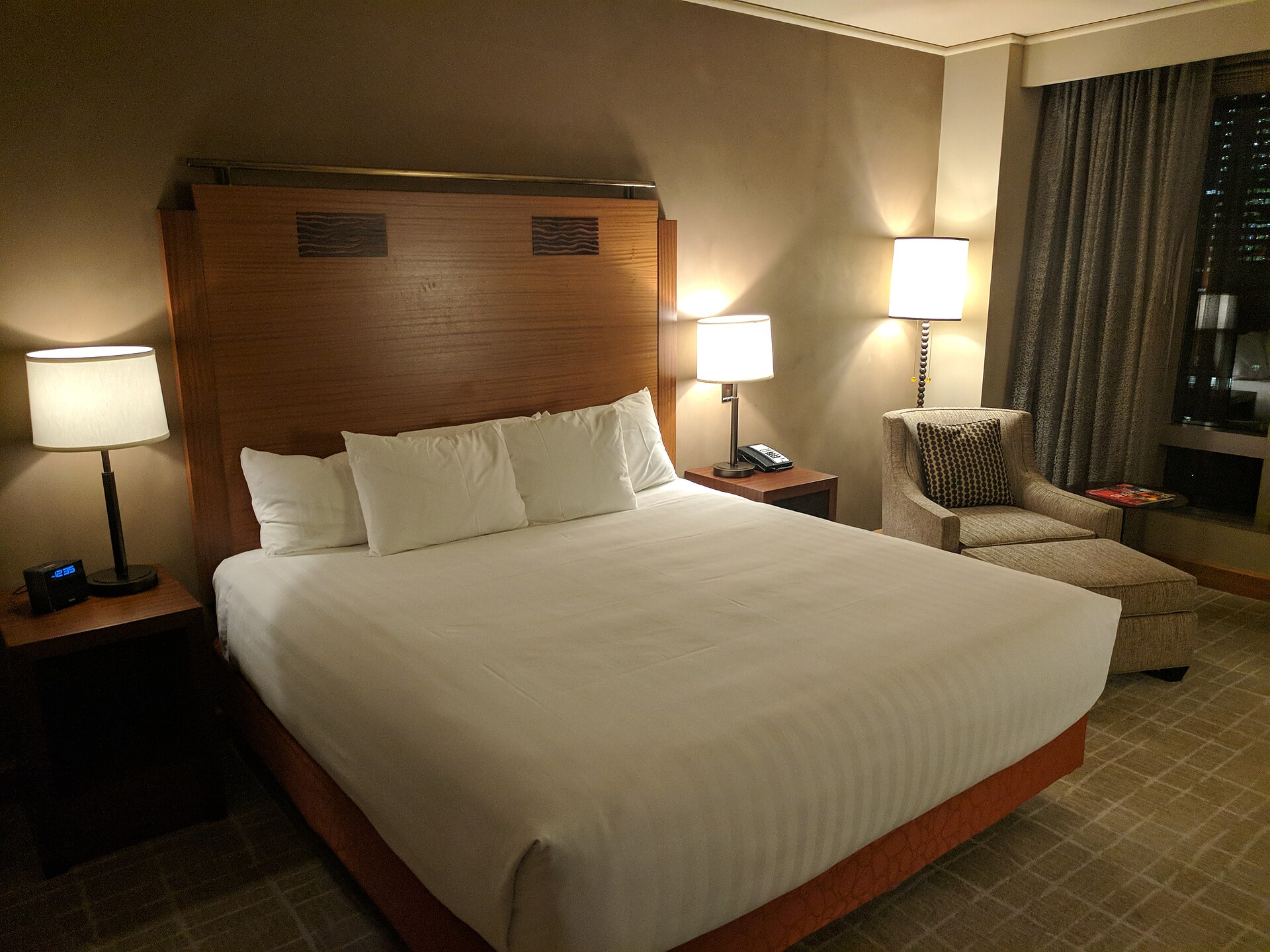 A freshly made bed in a hotel room