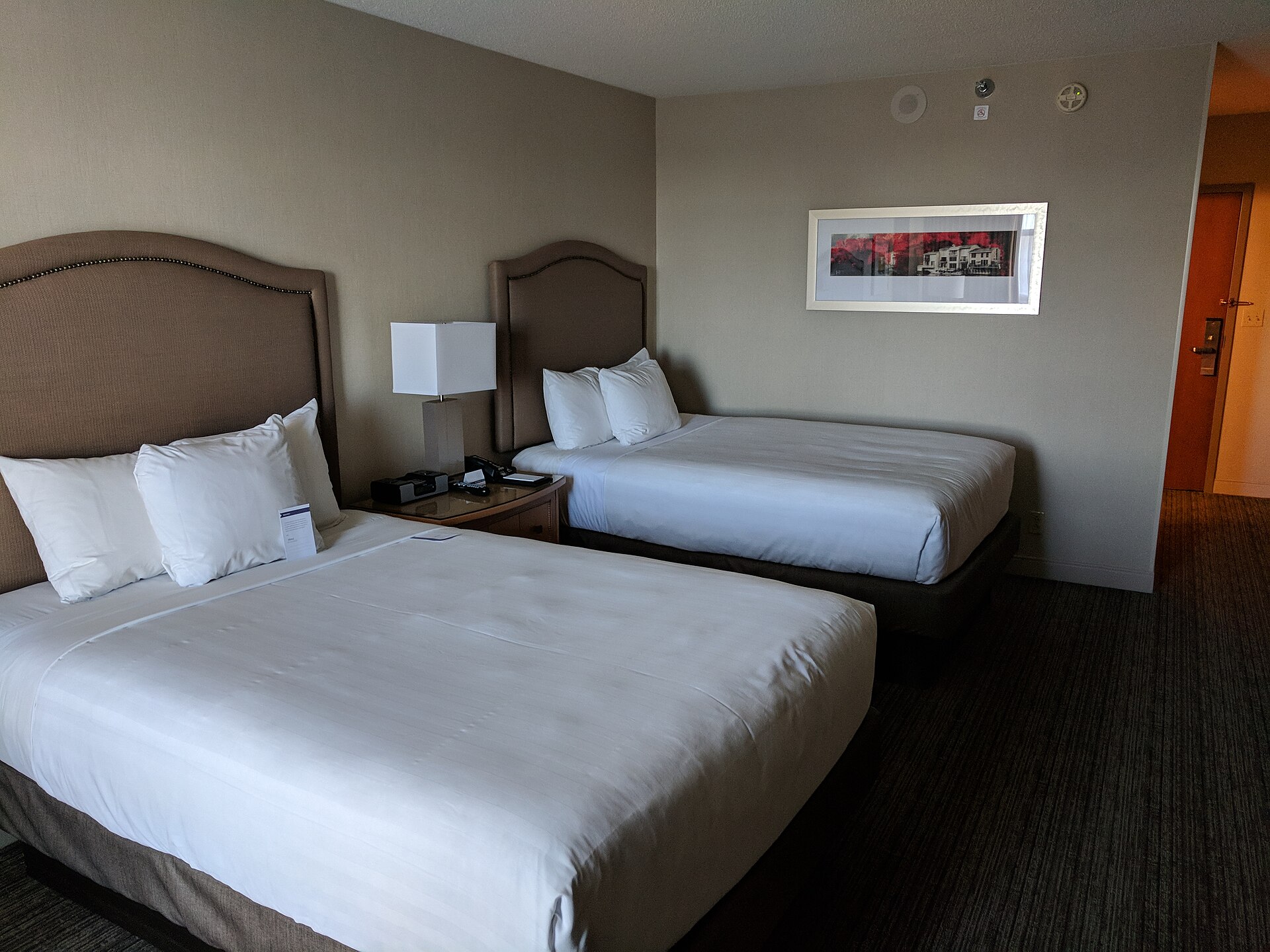 A second freshly made hotel bed after housekeeping