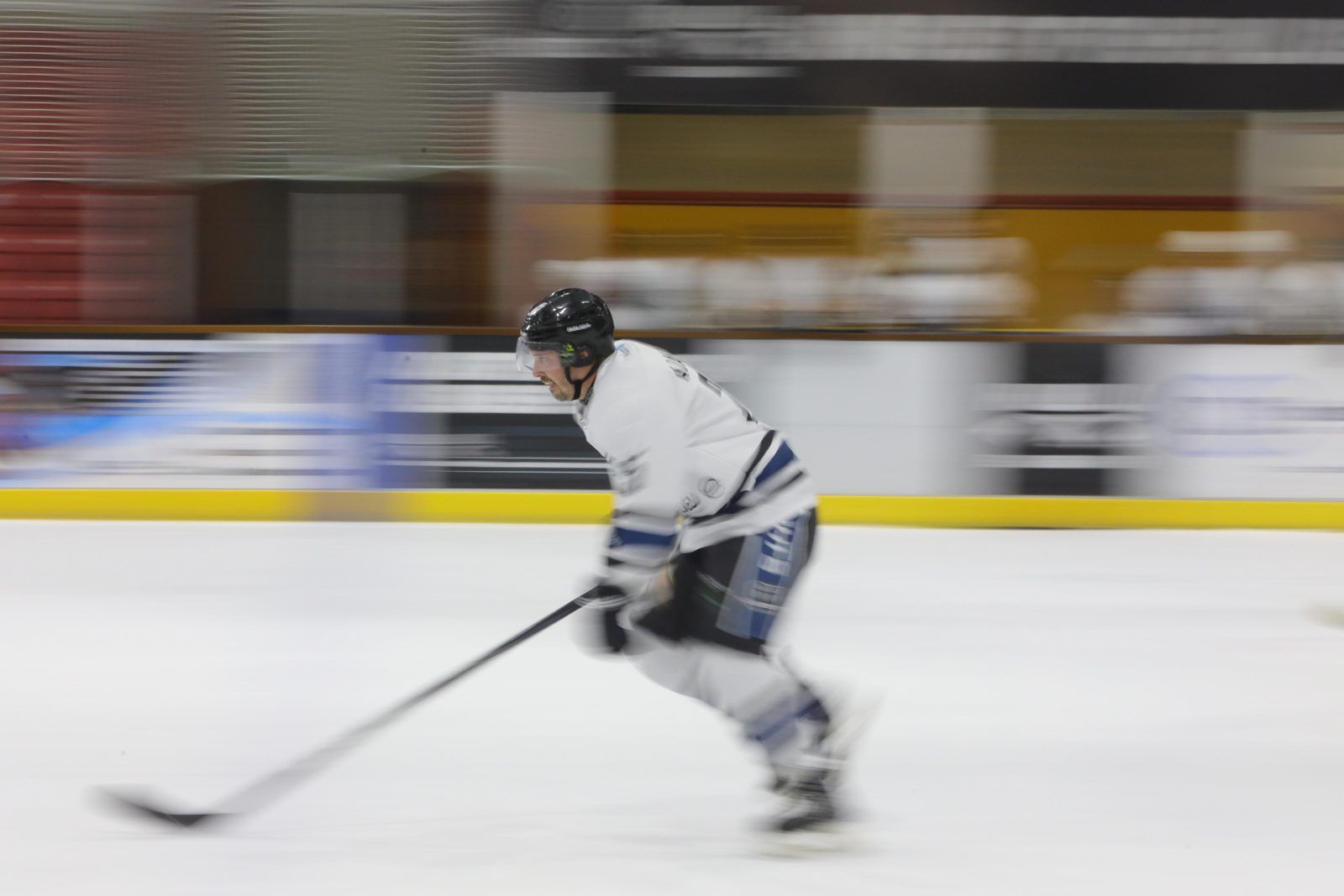 A player chases the puck during an ice hockey game