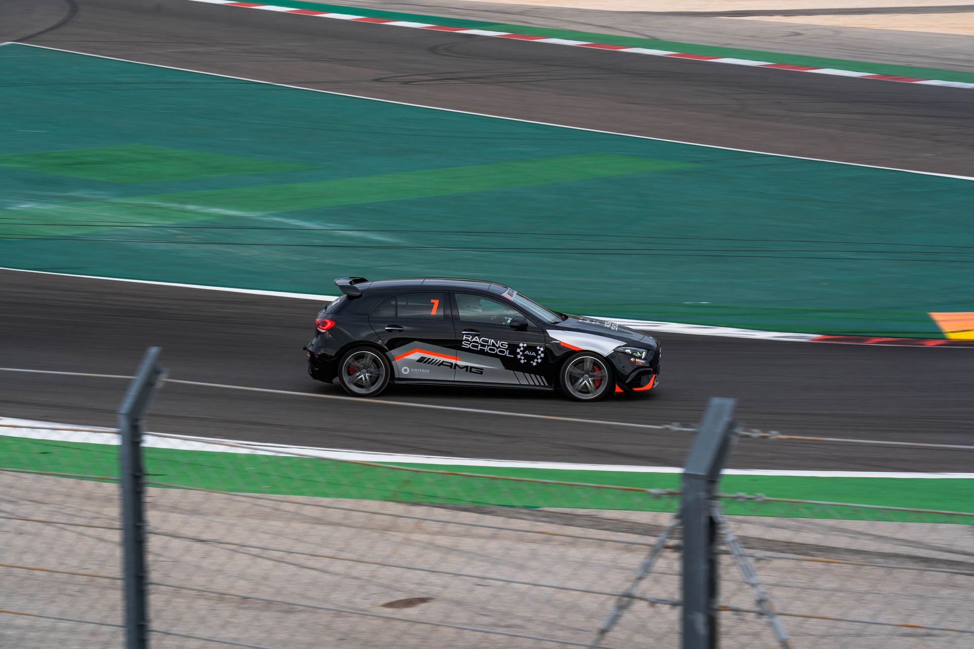 A race car speeds on a race track in Portugal