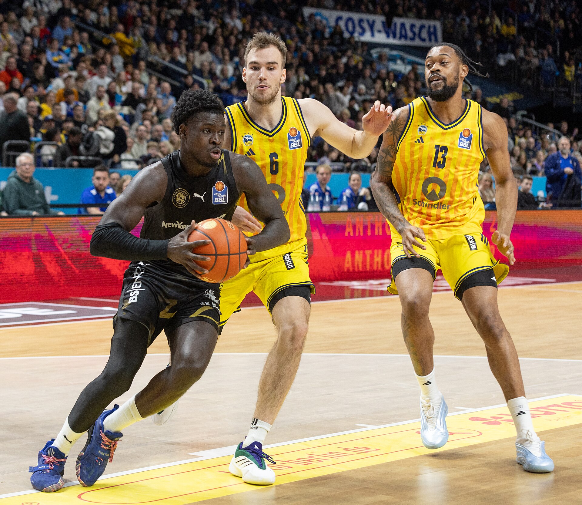 Basketball players battle for the ball in a game