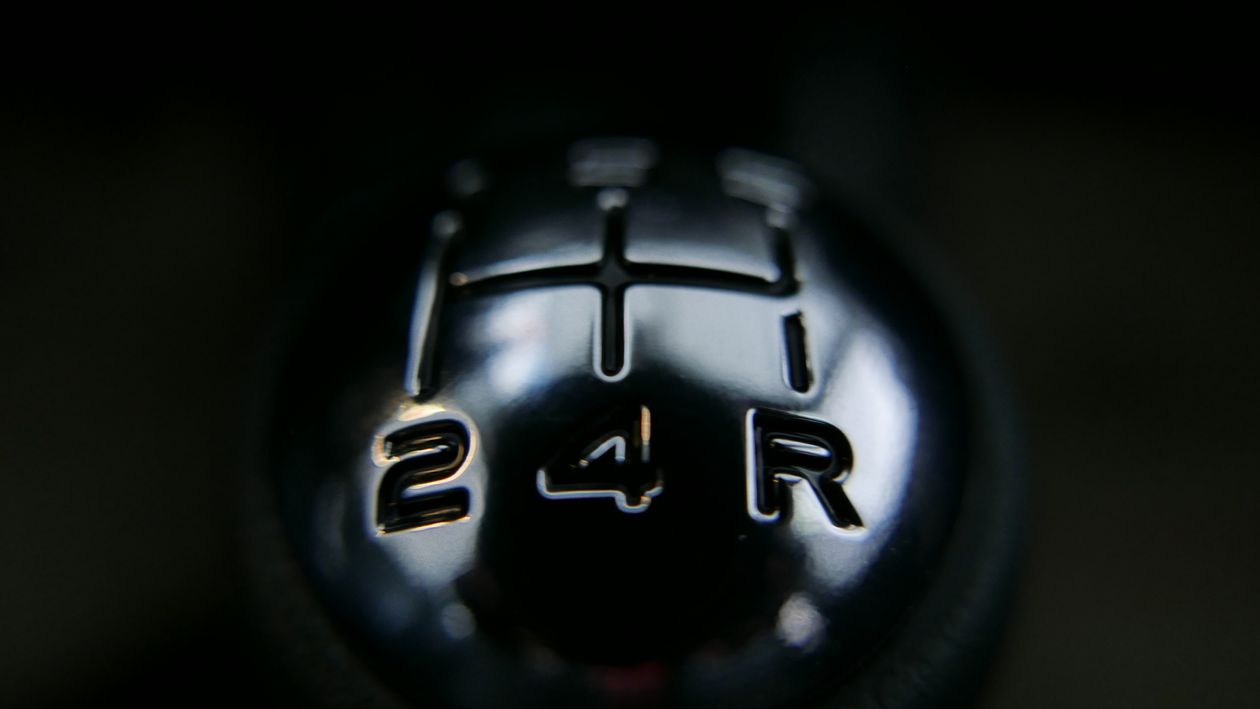 A close-up of a manual gear stick inside a car