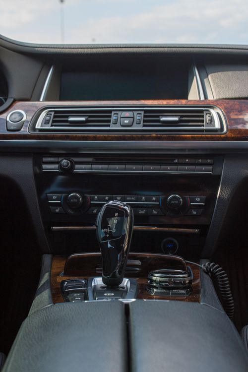 A car interior with a view of the dashboard and gear stick