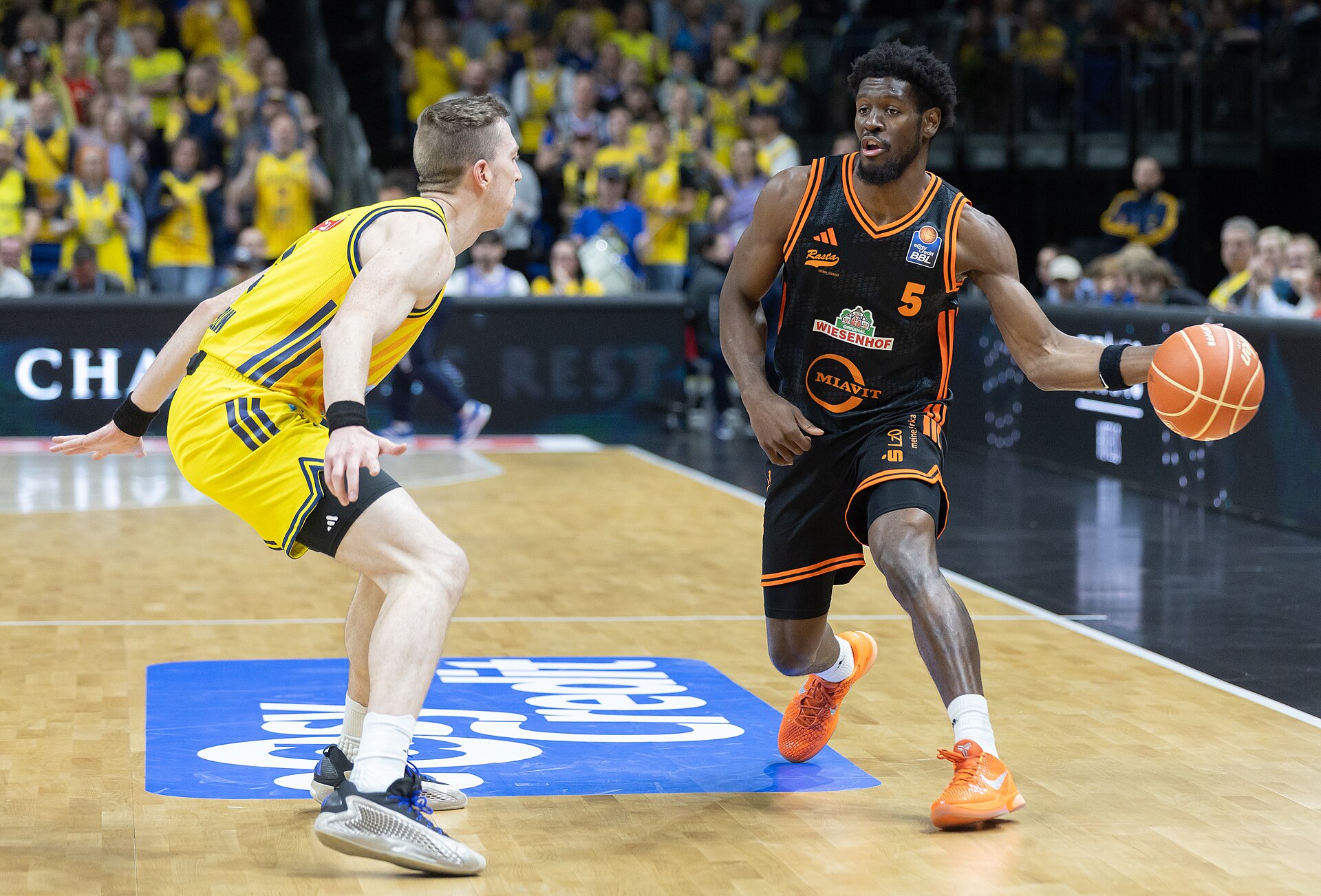 Basketball players compete for the ball in a game