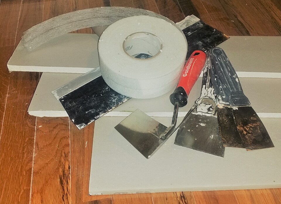Drywall panels and tools ready for a repair