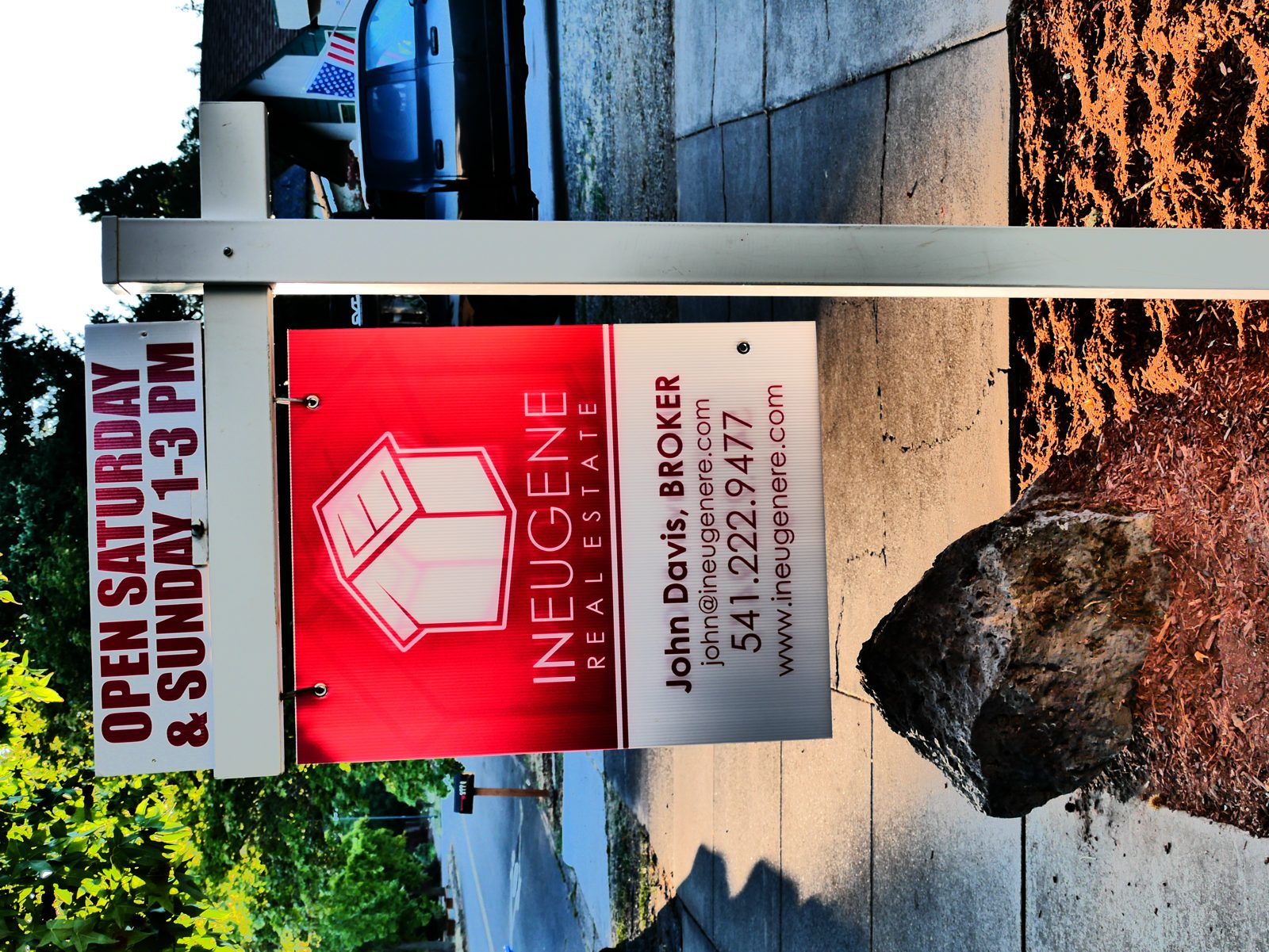 A home for sale sign in front of a house