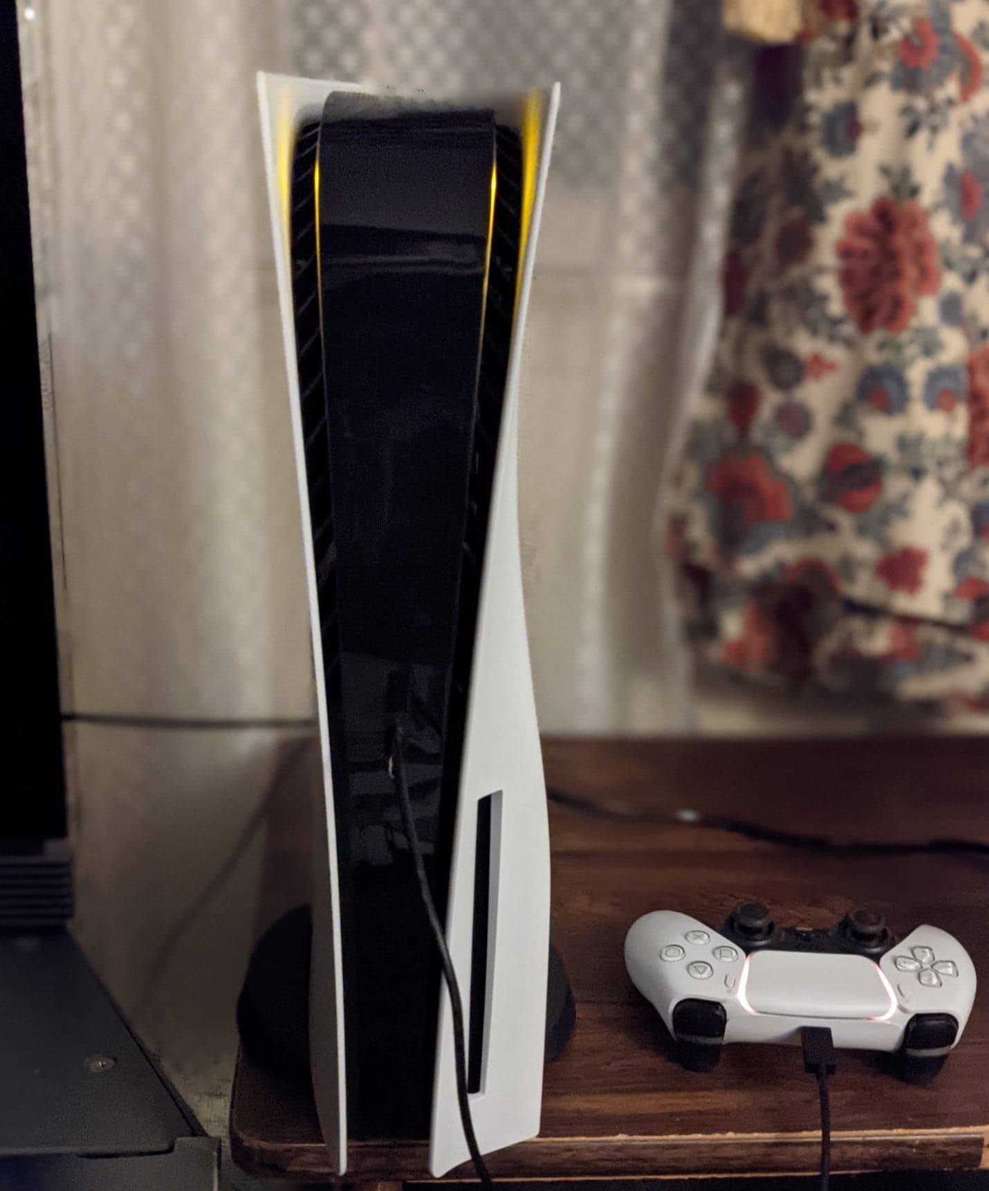 A PlayStation 5 console with a DualSense controller