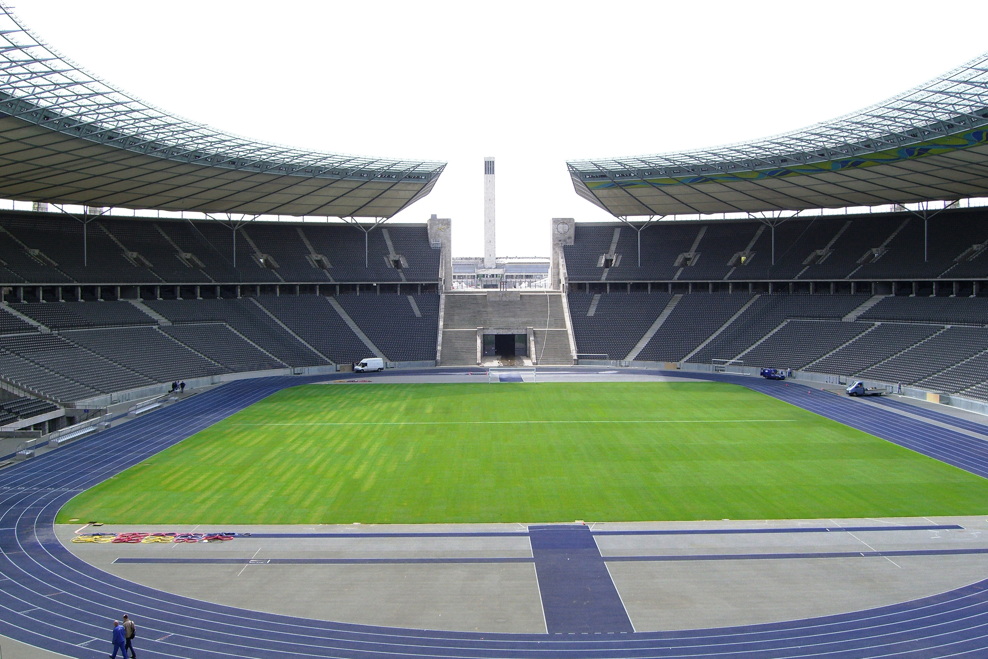 A football stadium with a green pitch