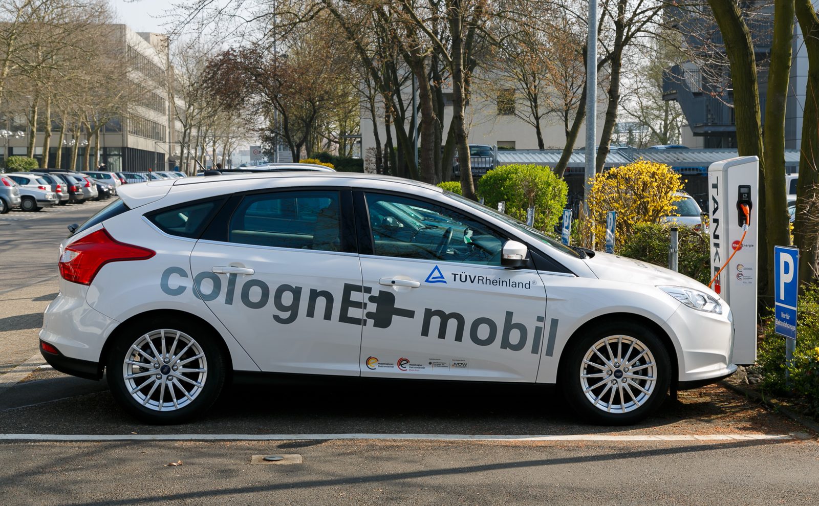 An electric car charging point in Cologne, Germany, with a car plugged in