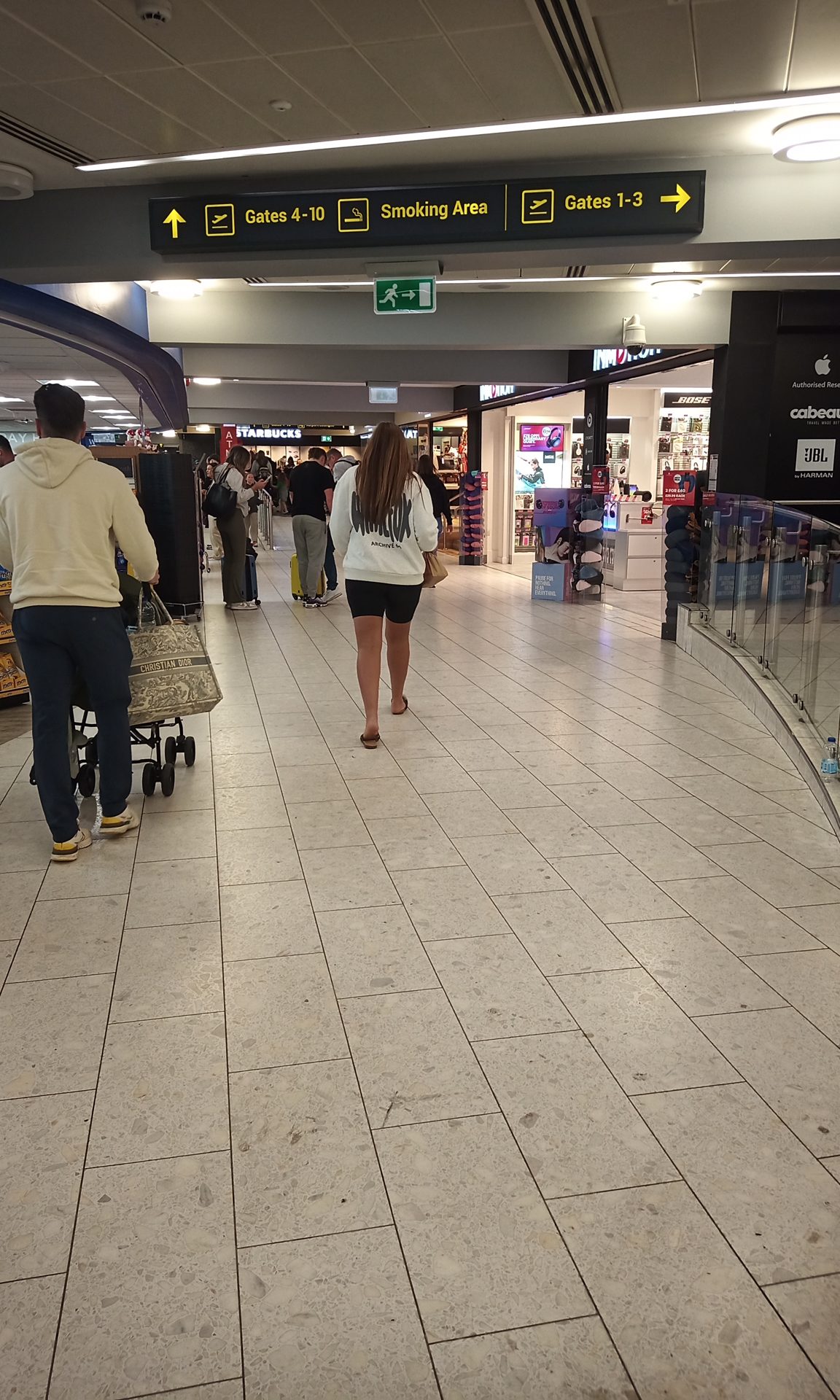 Passengers wait in an airport departures hall