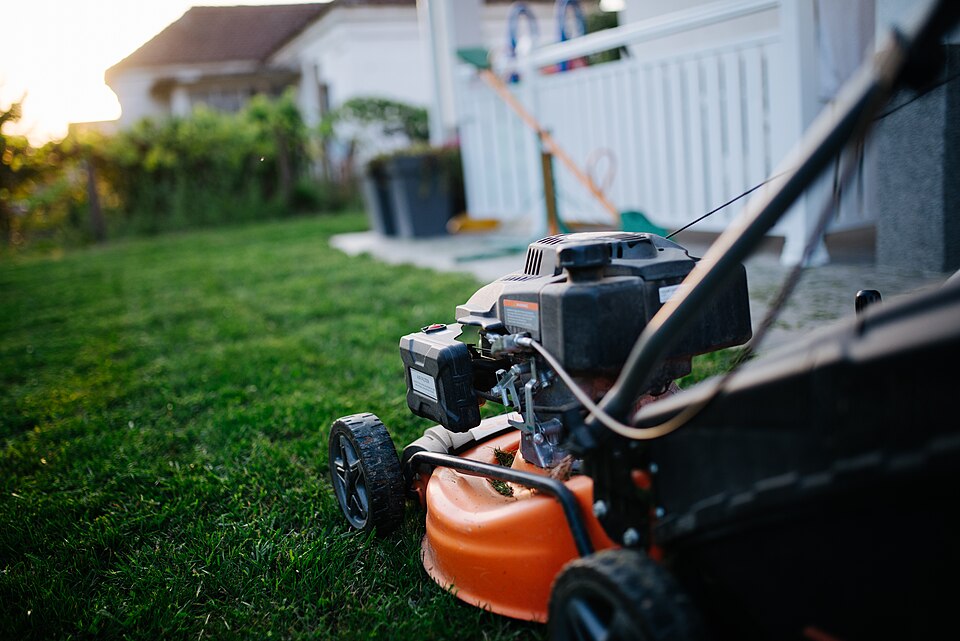A lawn mower on grass, seen up close