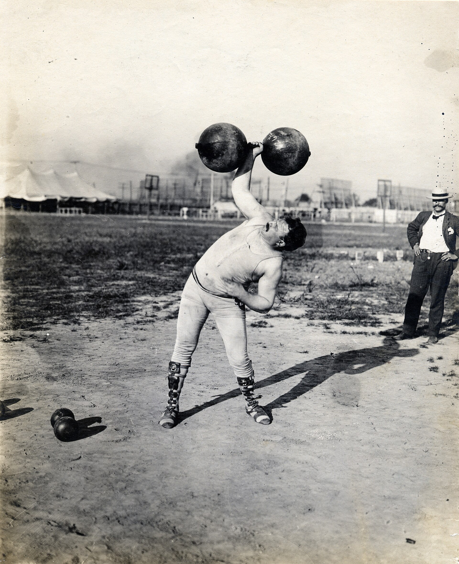 Fred Winters holding dumbbells after winning a dumbbell competition