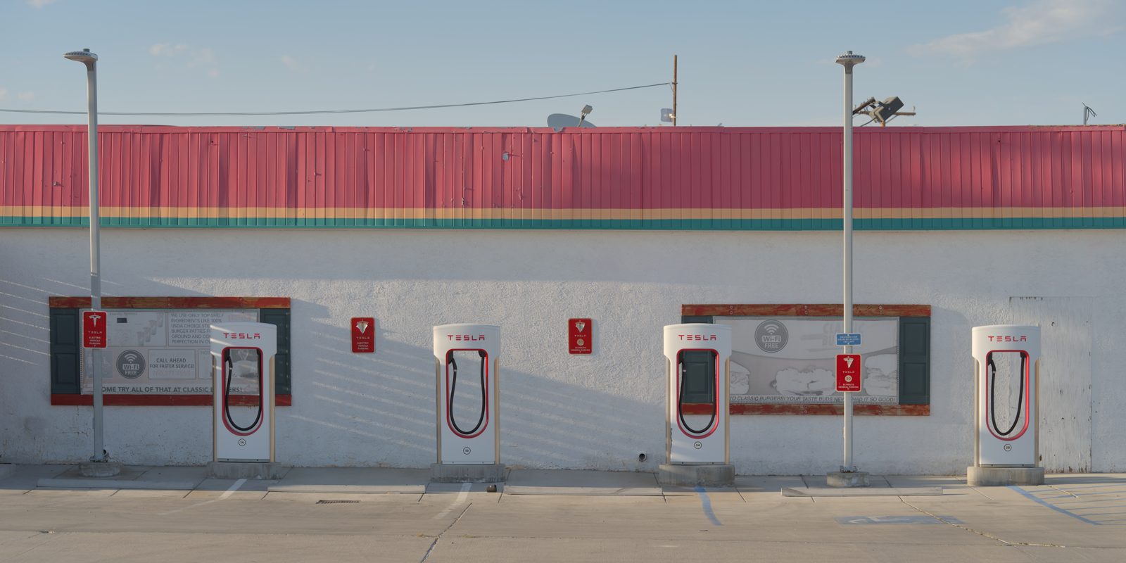 A Tesla Supercharger station with rows of charging stalls