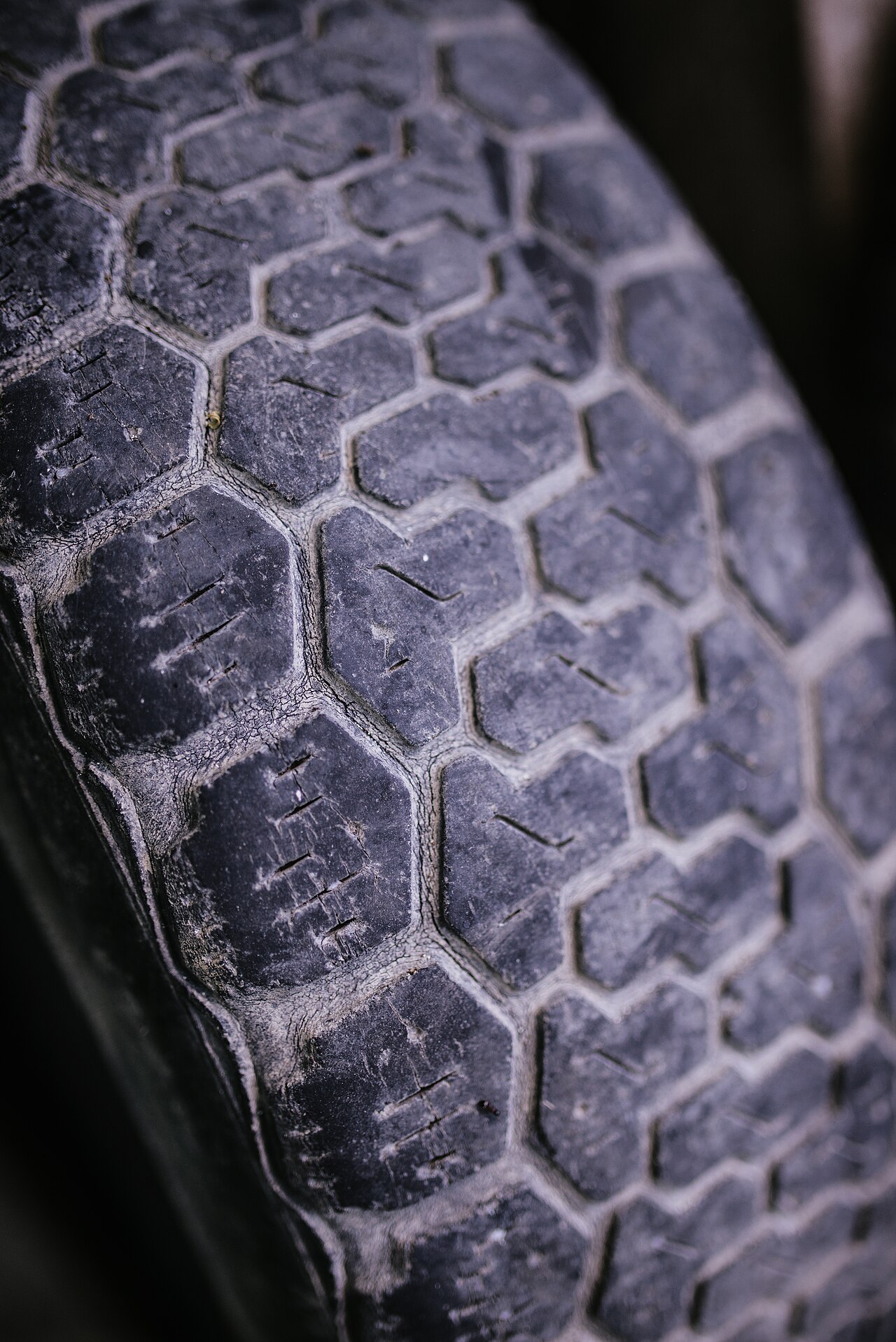 Close-up of a worn tire tread in a garage