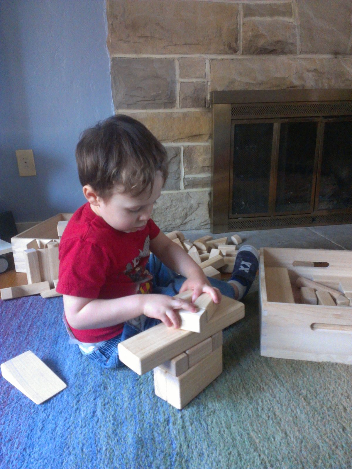 A child playing with wooden unit blocks