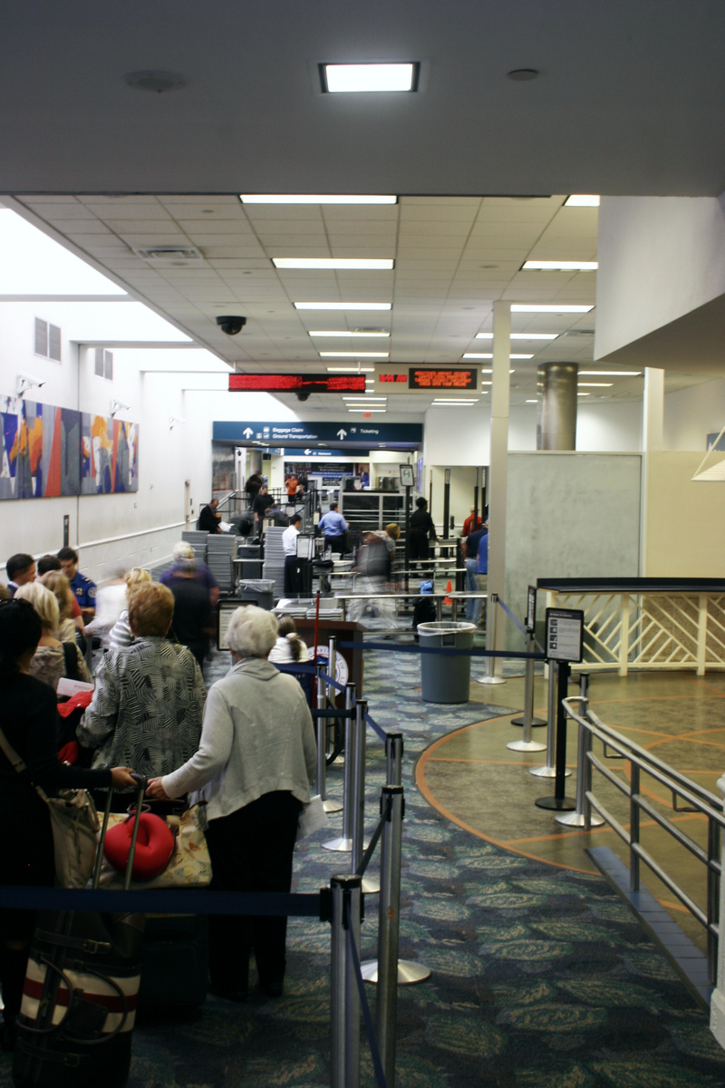 Travelers passing through an airport security checkpoint