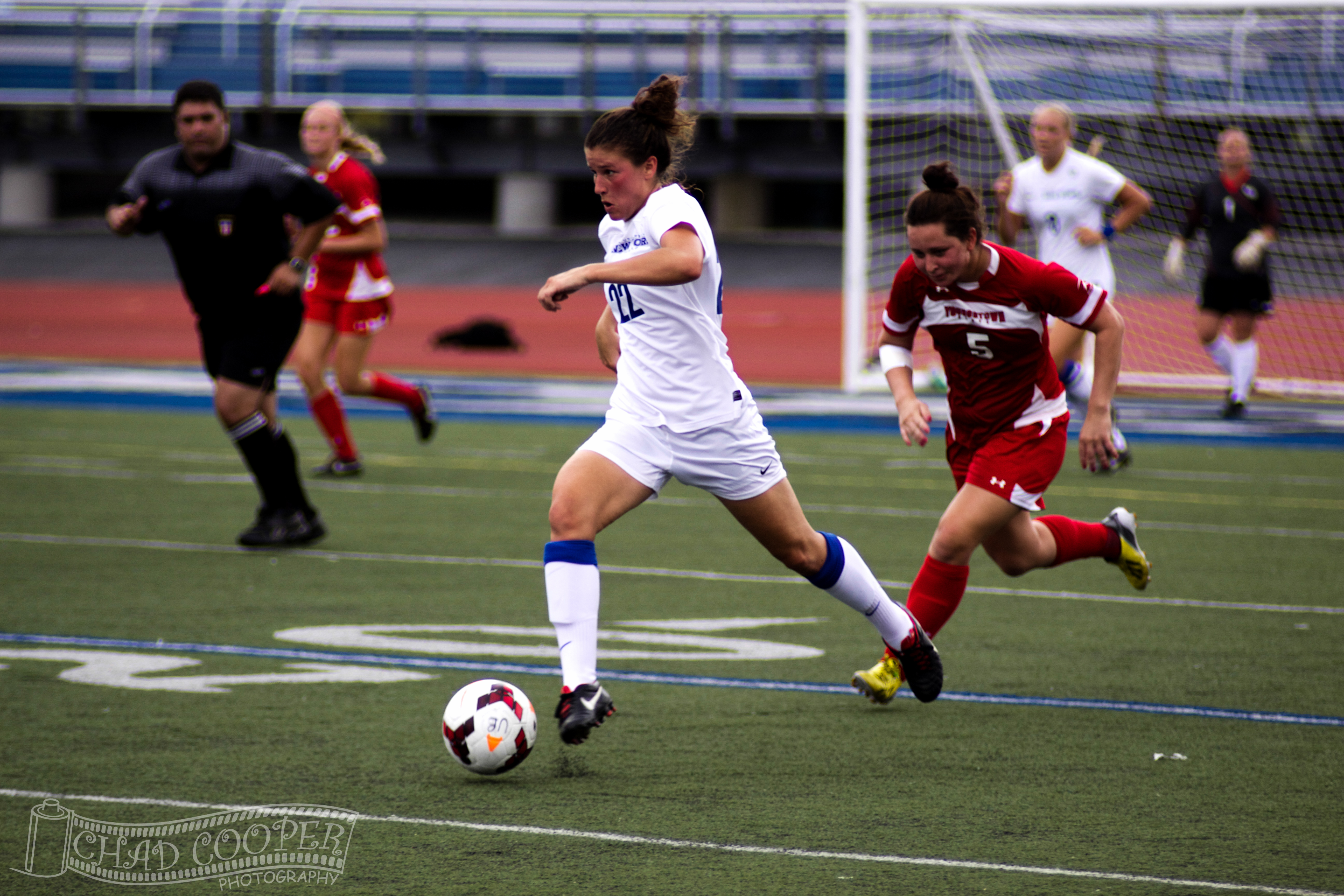 Women's soccer players fight for the ball in a match