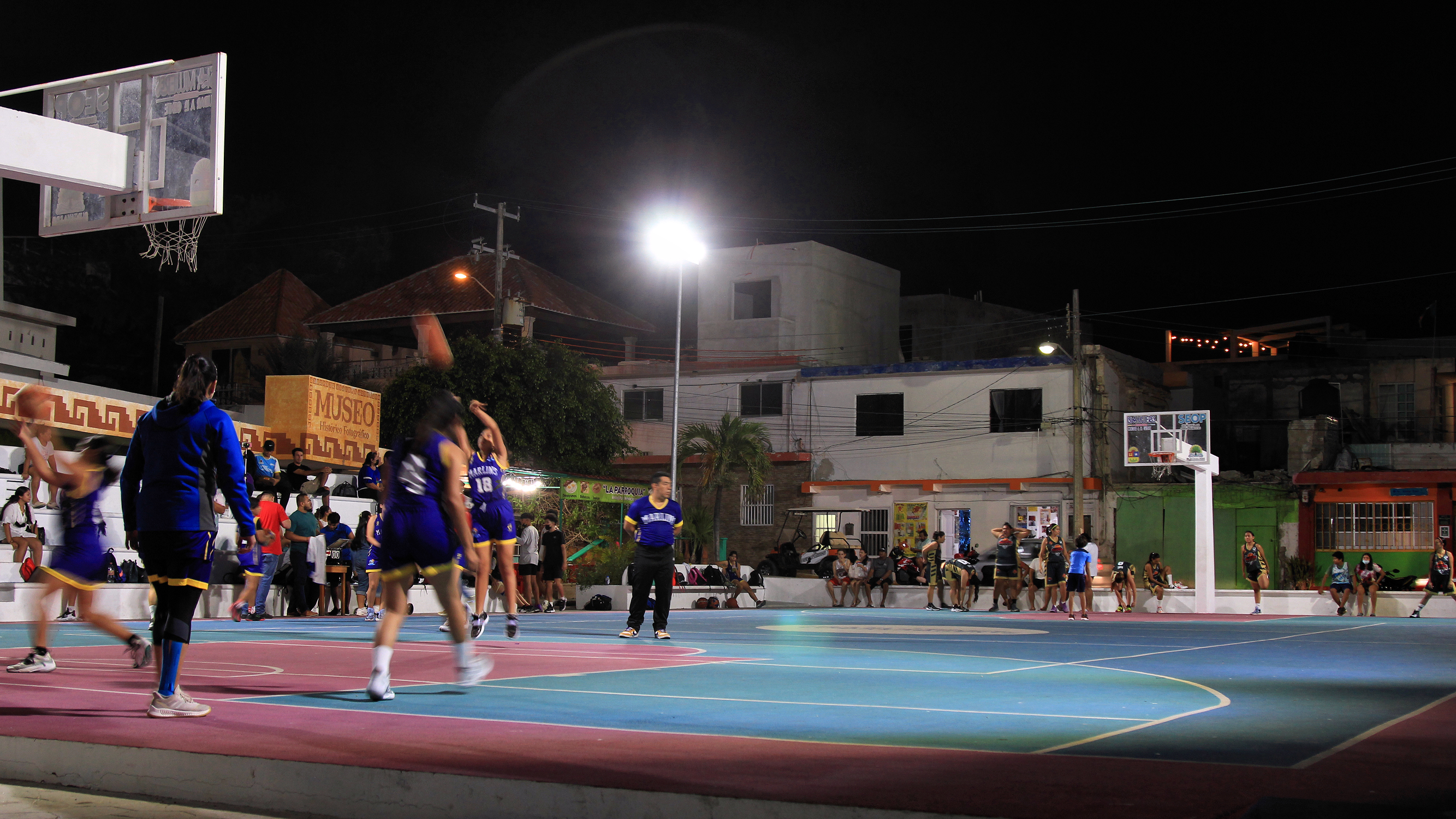 Basketball players warm up on the court before a game