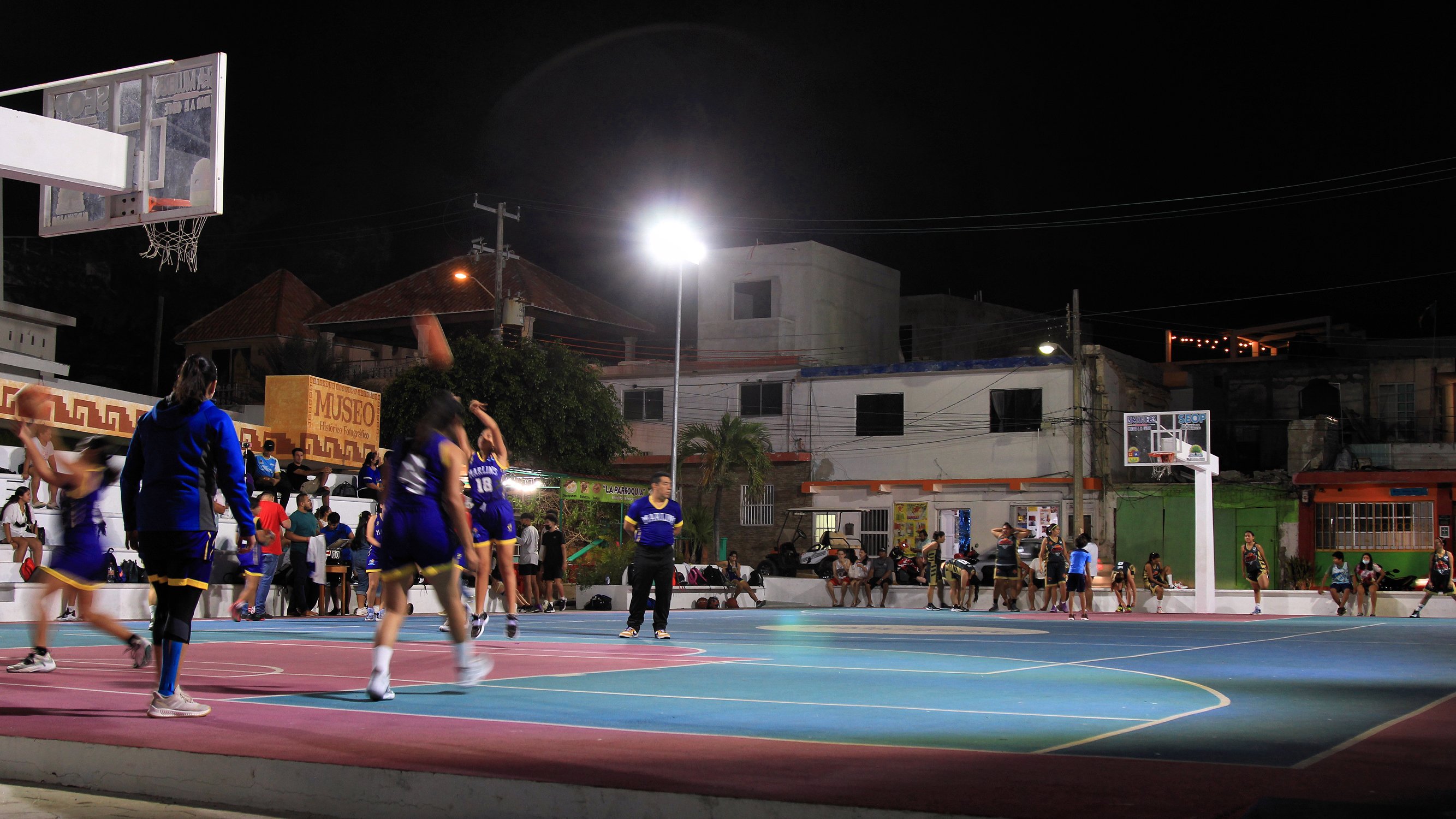 Basketball players warming up on a court