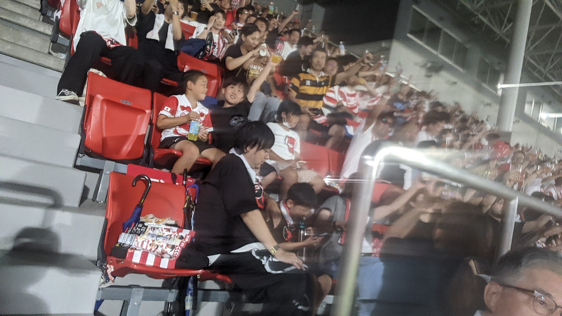 Rugby fans gather at a stadium for a match