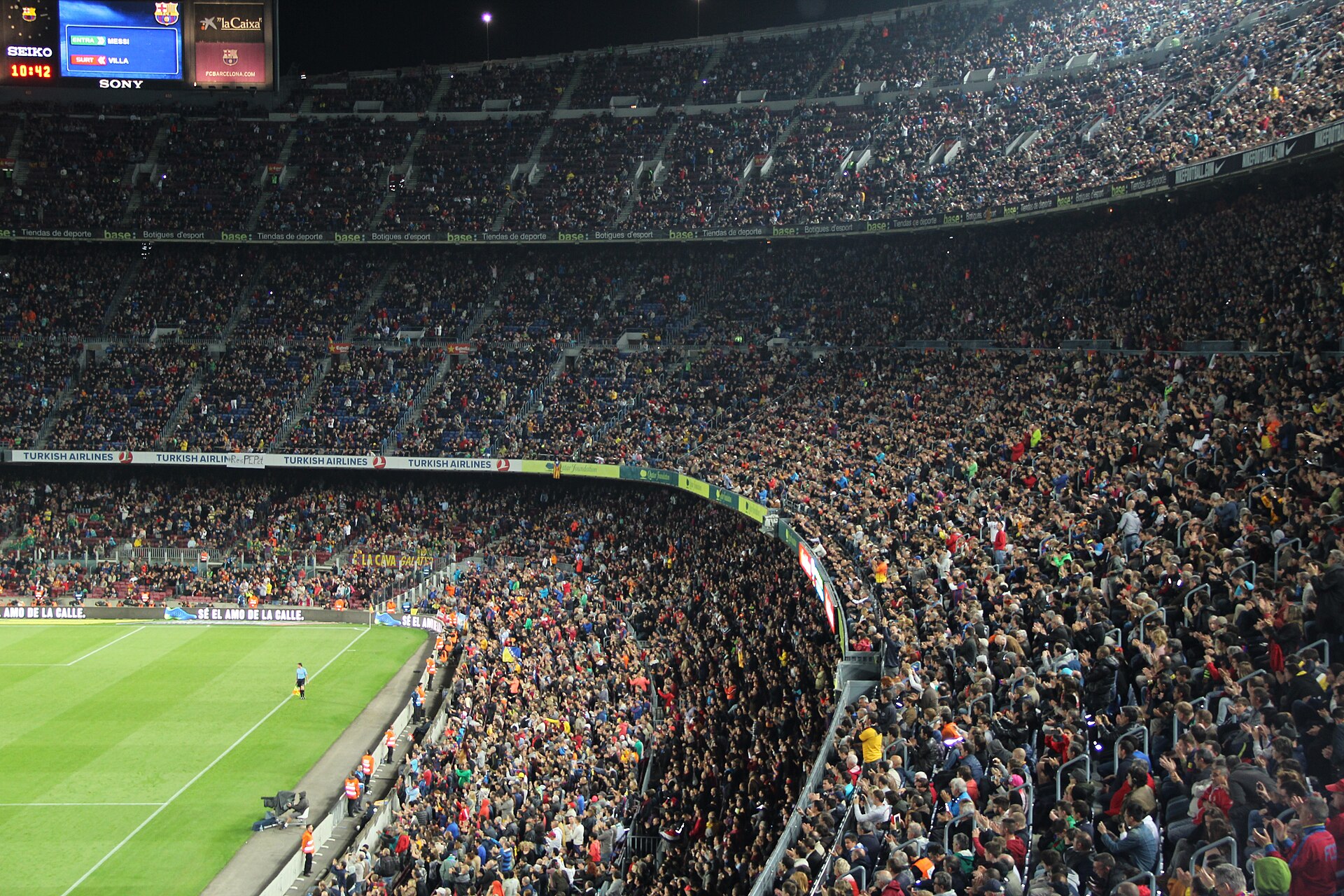 A packed football stadium during a night match