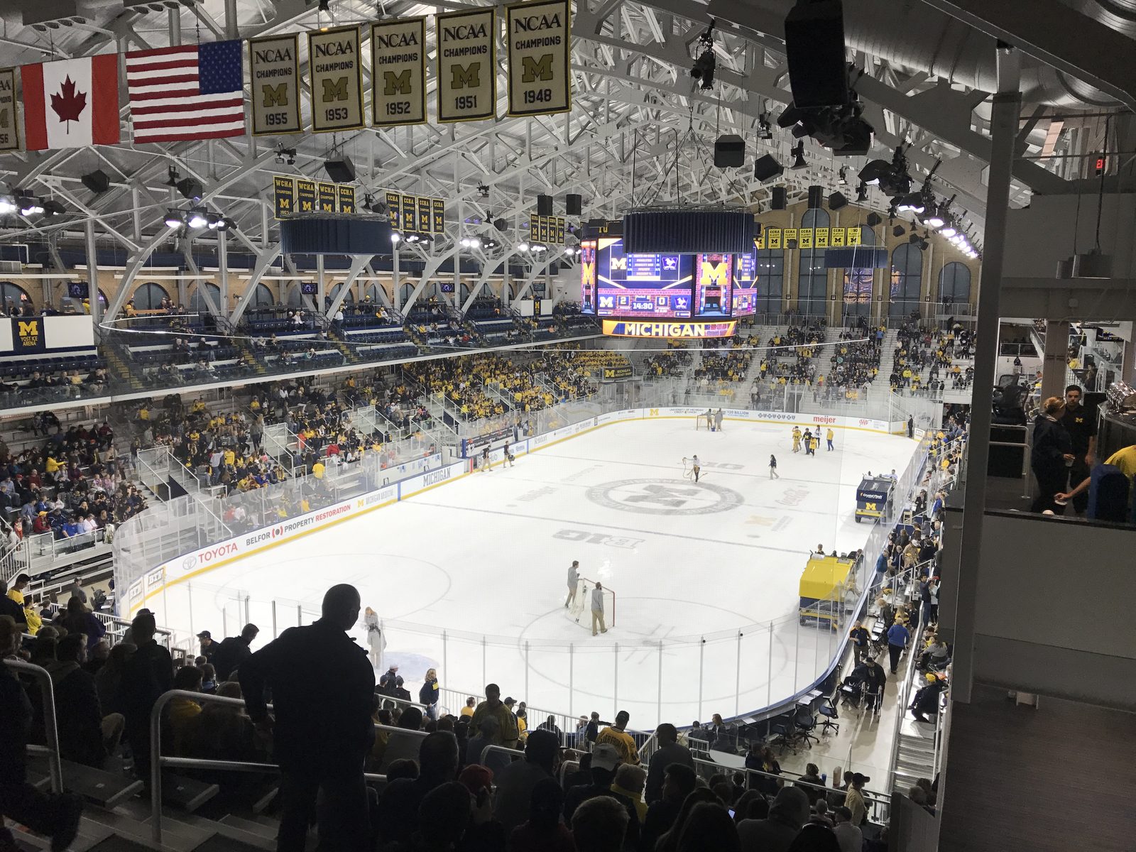 An ice hockey arena during a game with players on the ice