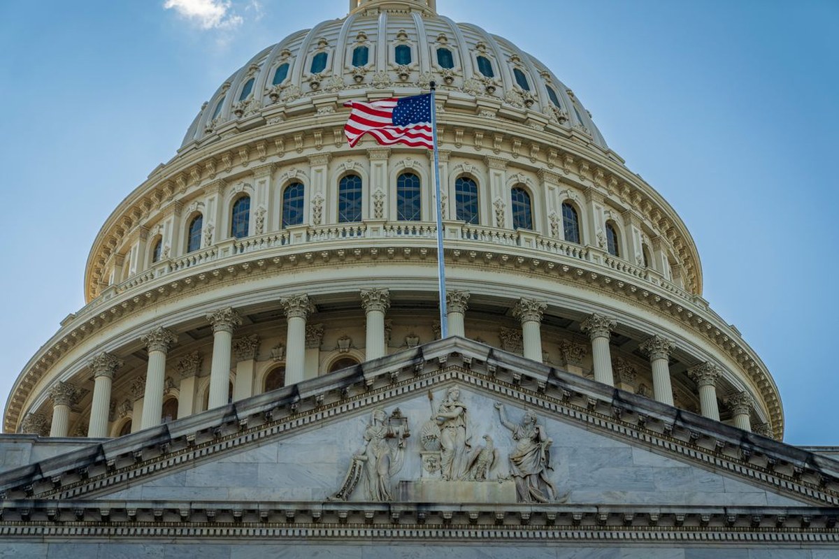 The United States Capitol dome with an American flag in Washington.