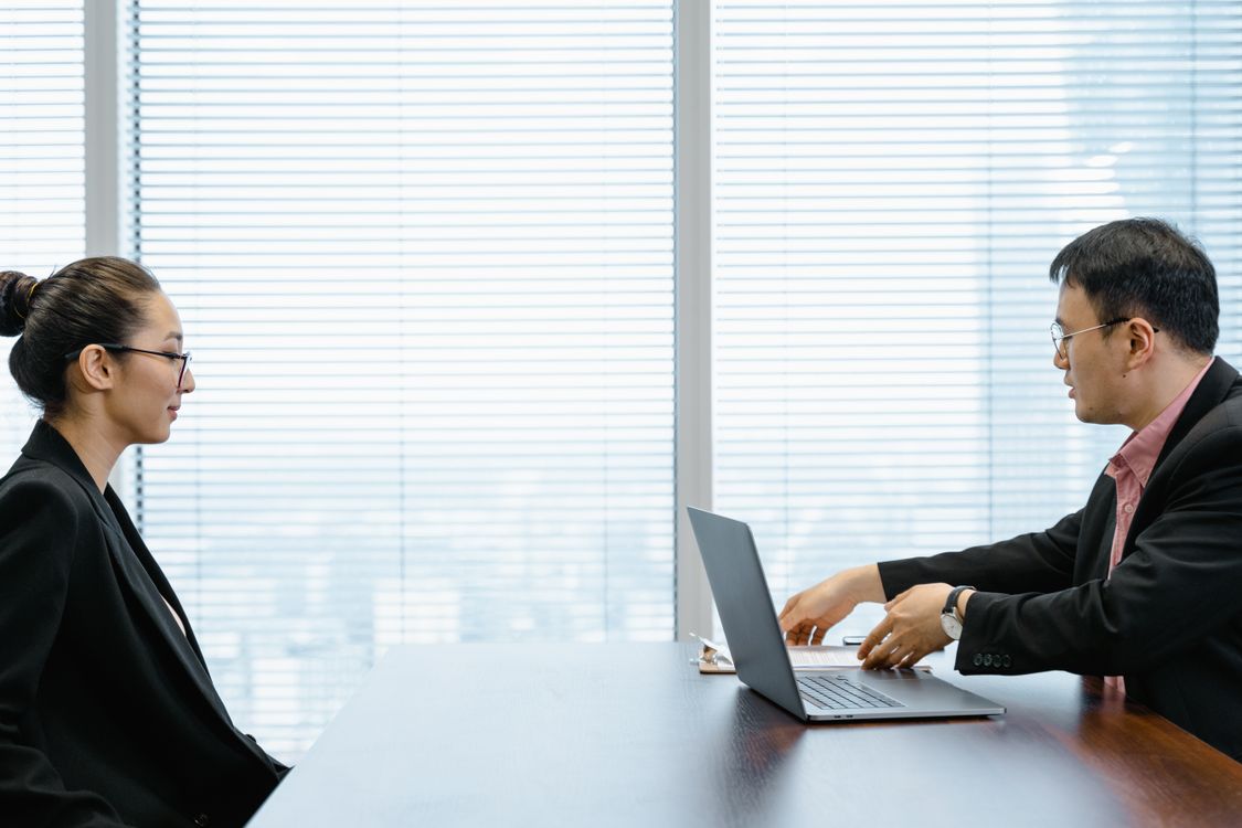 Two professionals in a job interview in a modern office