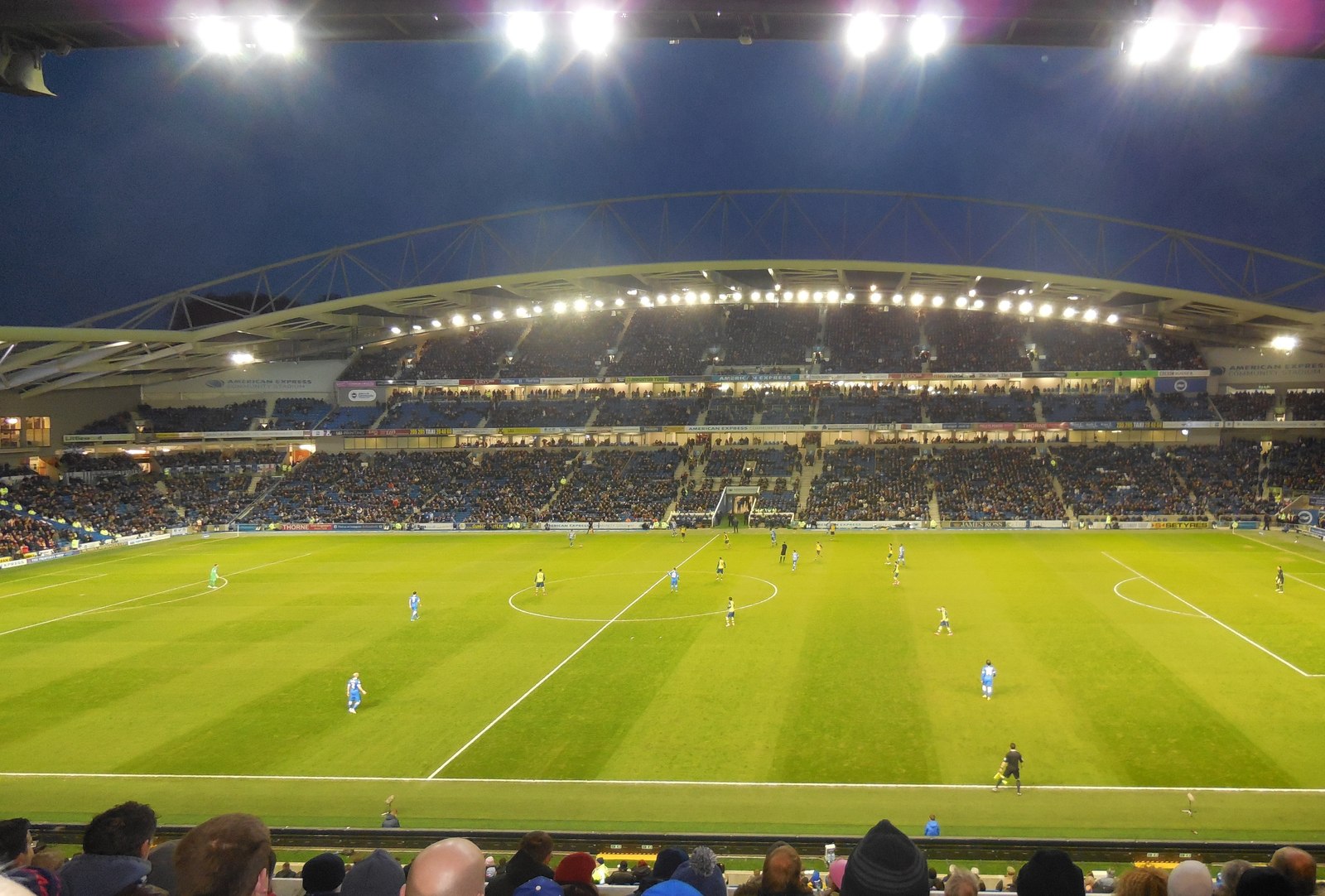 Brighton home stadium under floodlights at night